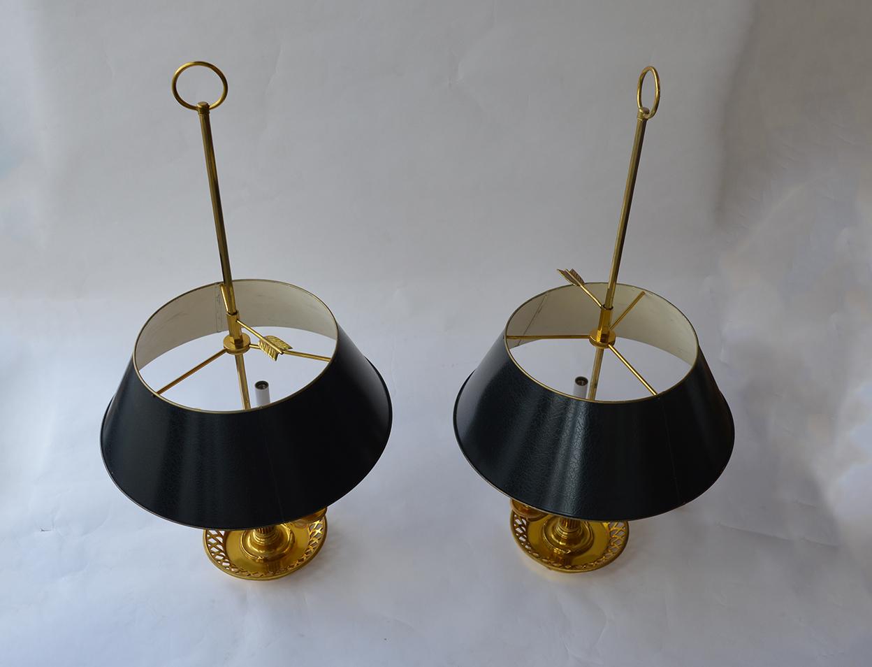 Two brass lamps with painted tole lampshades.