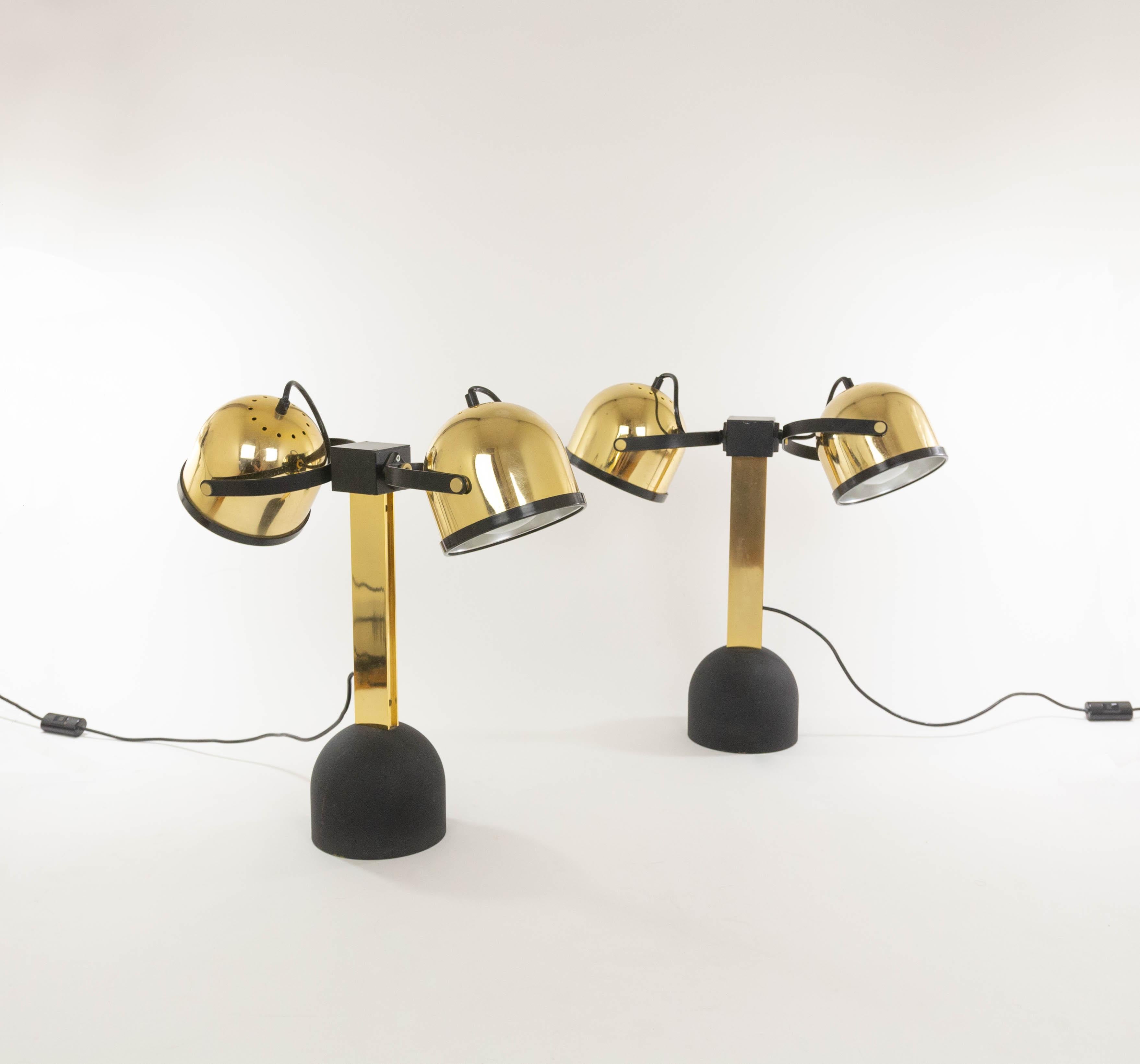 Pair of brass Trepiù table lamps designed by Gae Aulenti and Livio Castiglioni for Stilnovo in the 1970s. These table lamps are part of the Sistema Trepiù range.

The model consists of two spots which can be rotated in all directions and a cast iron