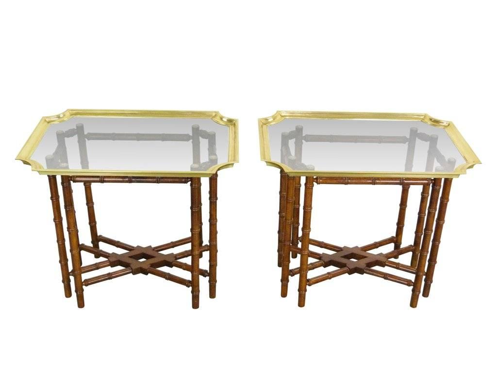 Vintage chinoiserie side/end tables by Baker. Featuring removable brass trim and glass top trays with faux bamboo bases. Although tray tables, they are very sturdy.