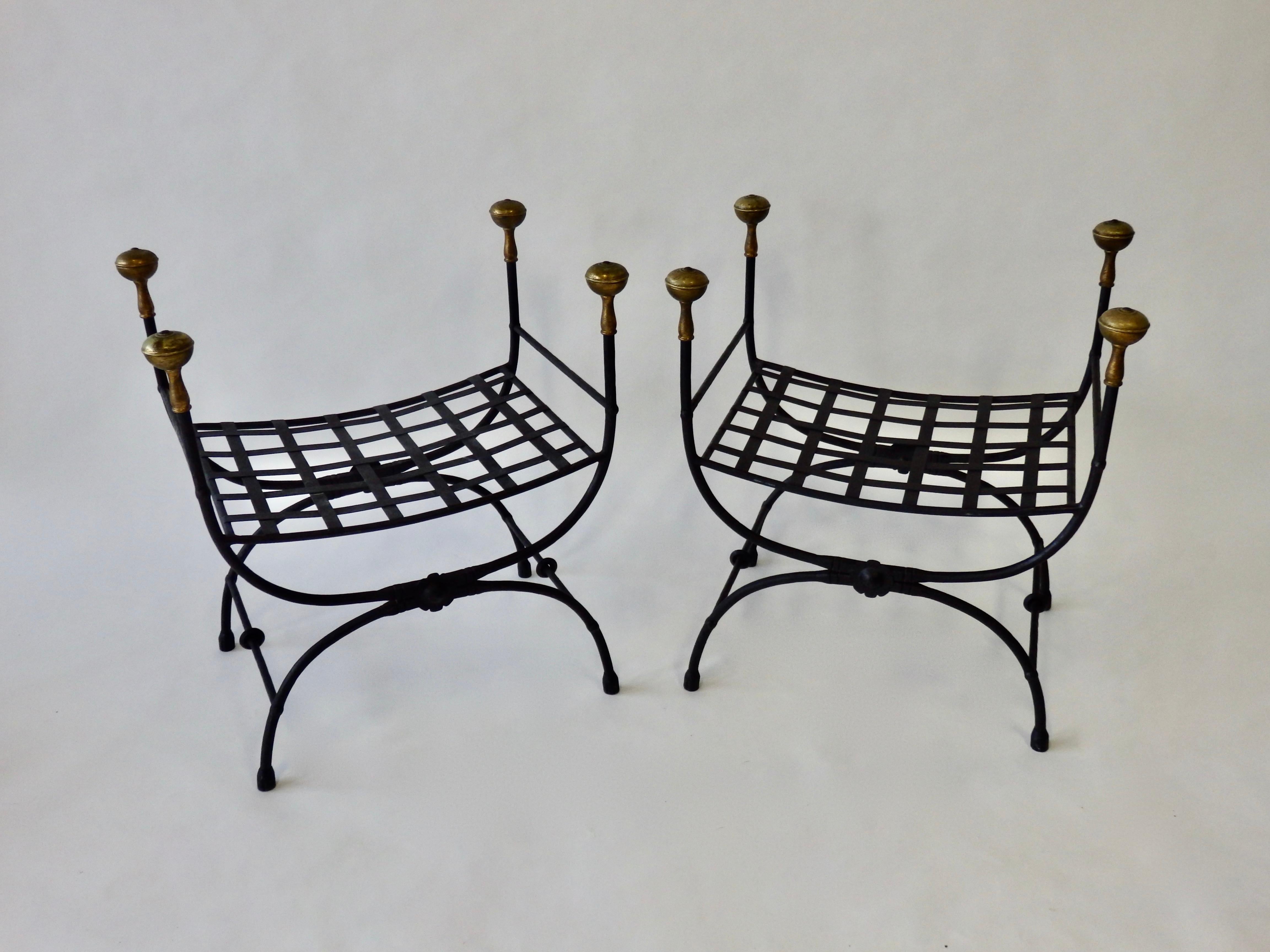 Pair of wrought iron benches with brass finial. Nicely detailed.