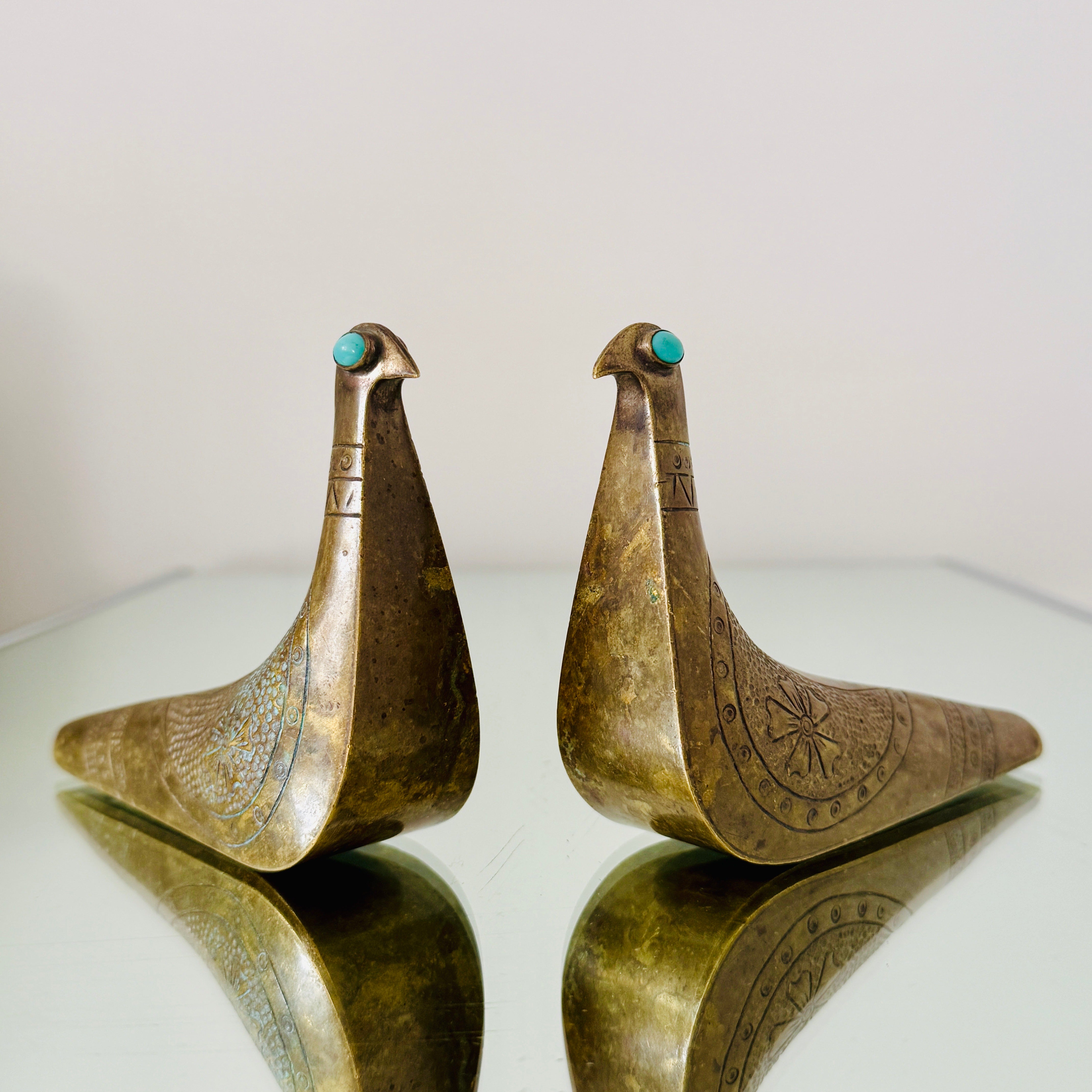 Pair of 1960's brass bird sculptures.  Joaquin Taller Tinta, an Ecuadorian silversmith, designed these pieces, and they are known for their unique blend of South American influences and modernist design.  The sculptures features unique engraved