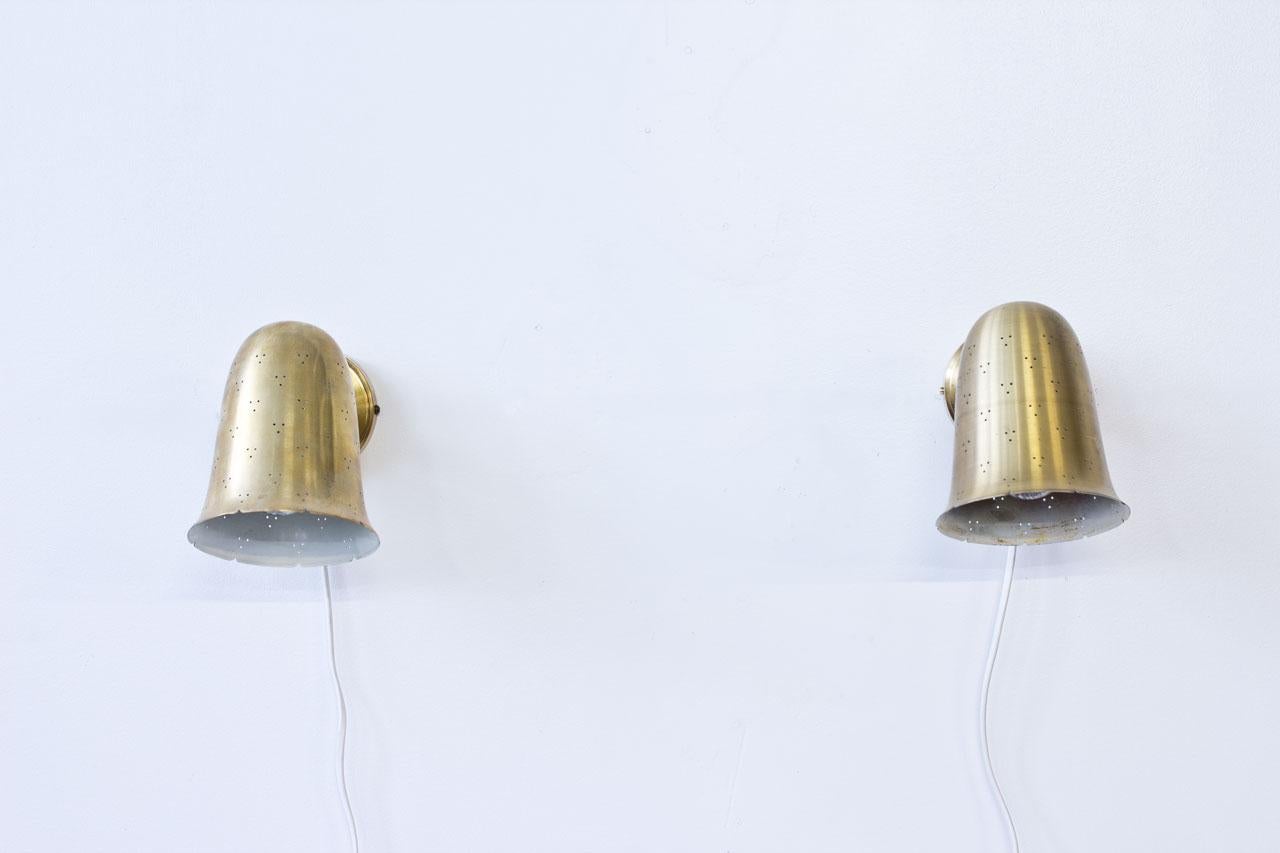 Pair of bell shaped wall lamps produced by Boréns at Borås in Sweden during the 1960s. Lamps made out of perforated polished solid brass. New electricity.