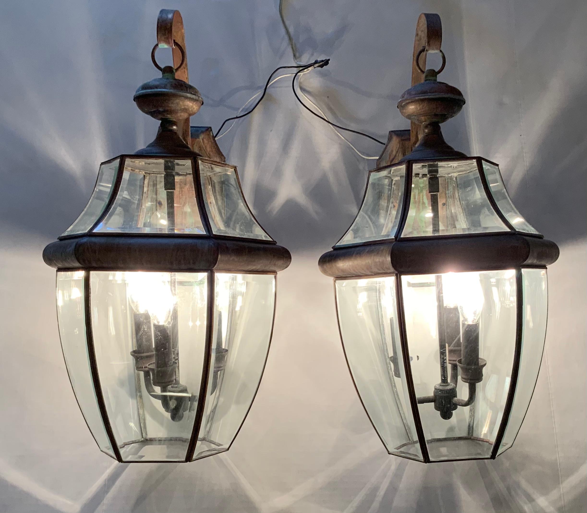 Pair of elegant wall lanterns made of solid brass, six sides of beveled glass, with three-light of 60/watt each. Up to US code ready to use.