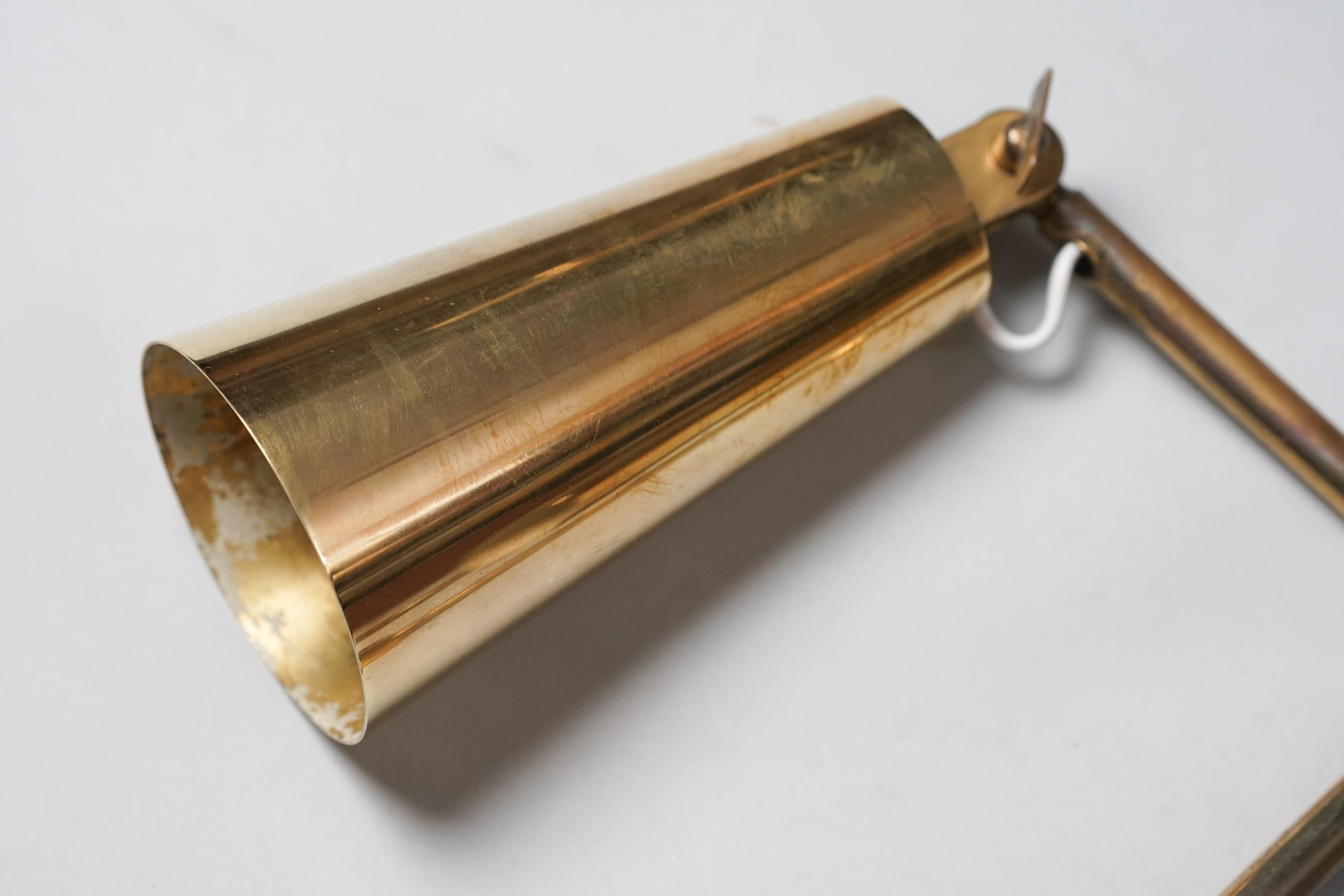 Pair of brass wall lights model 9459, designed by Paavo Tynell, manufactured by Taito Oy, 1960s.  Rare version. Good vintage condition, minor patina consistent with age and use. The wall lights are sold as a set. 
Iconic Paavo Tynell design. 

Paavo