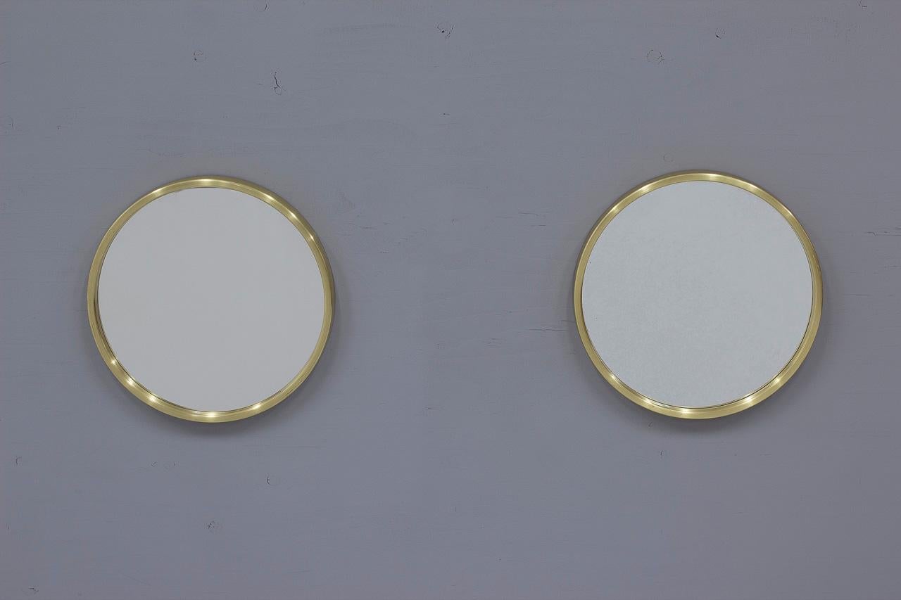 Stunning and chic pair of model 131 brass mirrors designed by Nils Troed. Manufactured by his own company Glasmäster Markaryd in Sweden during the 1960s. Good vintage condition with patina and wear consistent with age and use.

Those beautiful