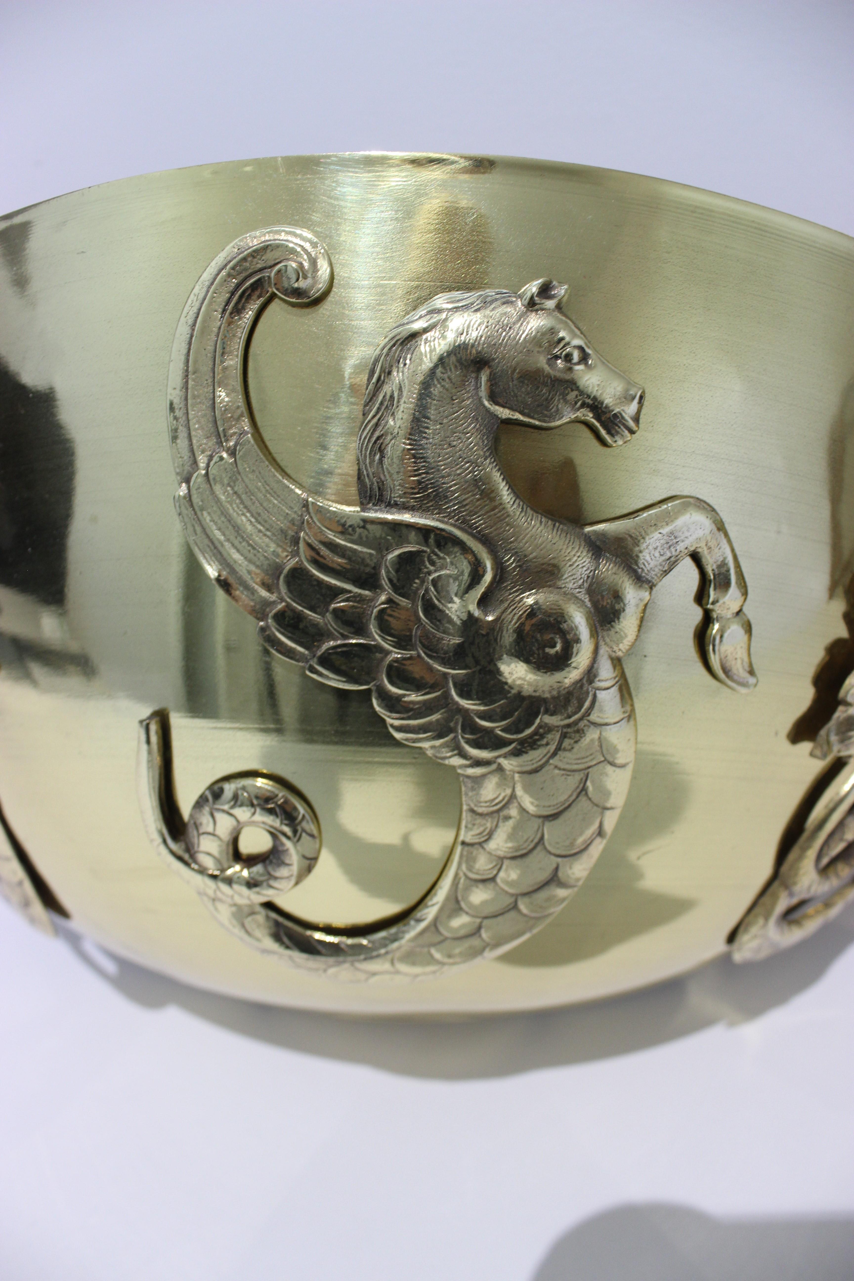 This stylish and chic pair of wall-mount cache pot were acquired from a Palm Beach estate and they have been professionally polished and lacquered. The pieces are detailed with three hippocamus. 

Note: The set could also be converted into wall