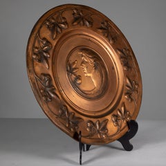 WMF. A pair of brass wall plaques embossed with a lady's and gentleman's heads