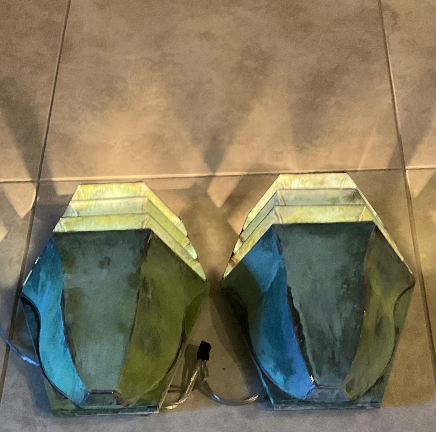 Pair of elegant wall sconces hand crafted from solid brass beautiful patina, with one 60/watt light each, projecting the light upward, great decorative fixture for any location indoor. Not suitable for wet locations.
