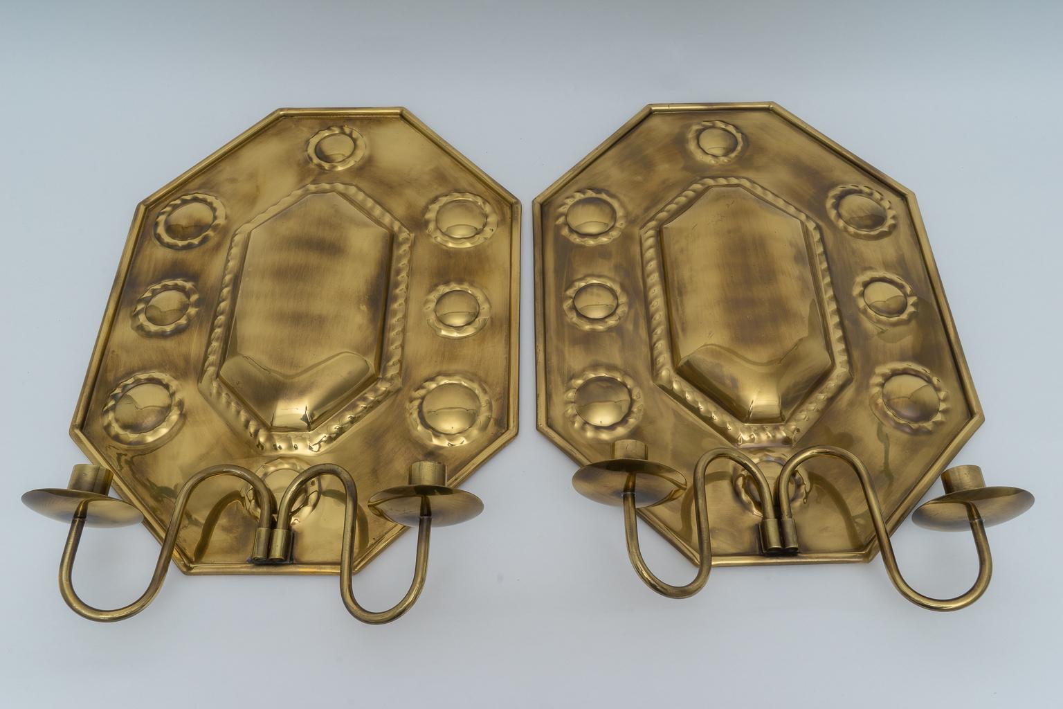 This stylish pair of handcrafted brass candle wall scones were acquired from a Palm Beach estate and could be used with candles or converted to electric.