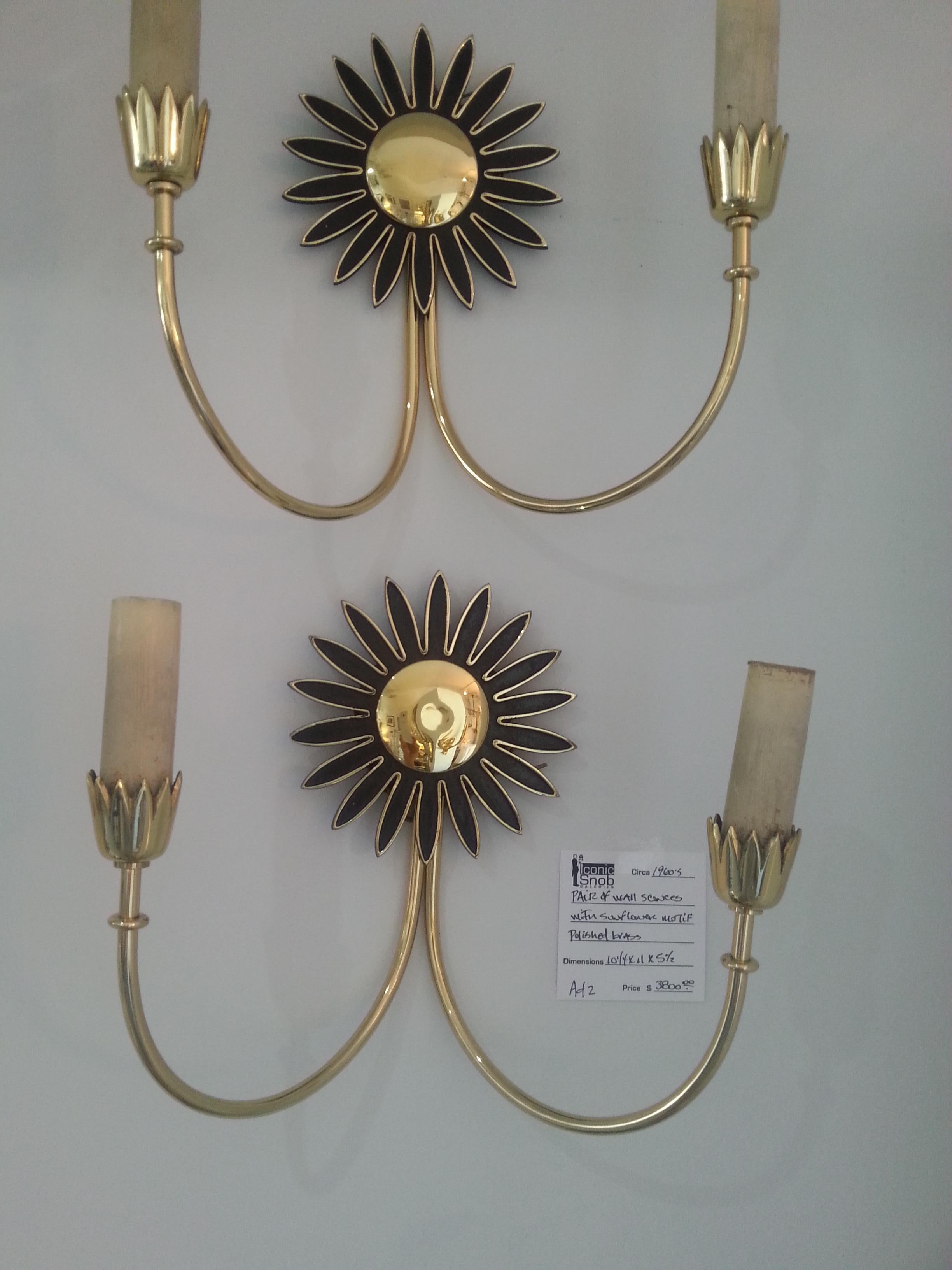 This stylish and chic pair of wall sconces were purchased in Rome, Italy and date to the 1960s. They have been professionally polished and have a clear lacquer finish so no tarnishing in the future. And the candle sleeves are carved wood that can be