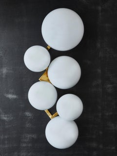 Pair of Brass Wall Sconces with Different Sized White Glass Globes