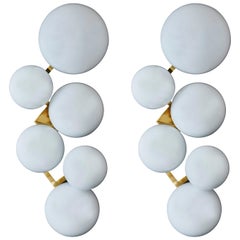 Pair of Brass Wall Sconces with Different Sized White Glass Globes
