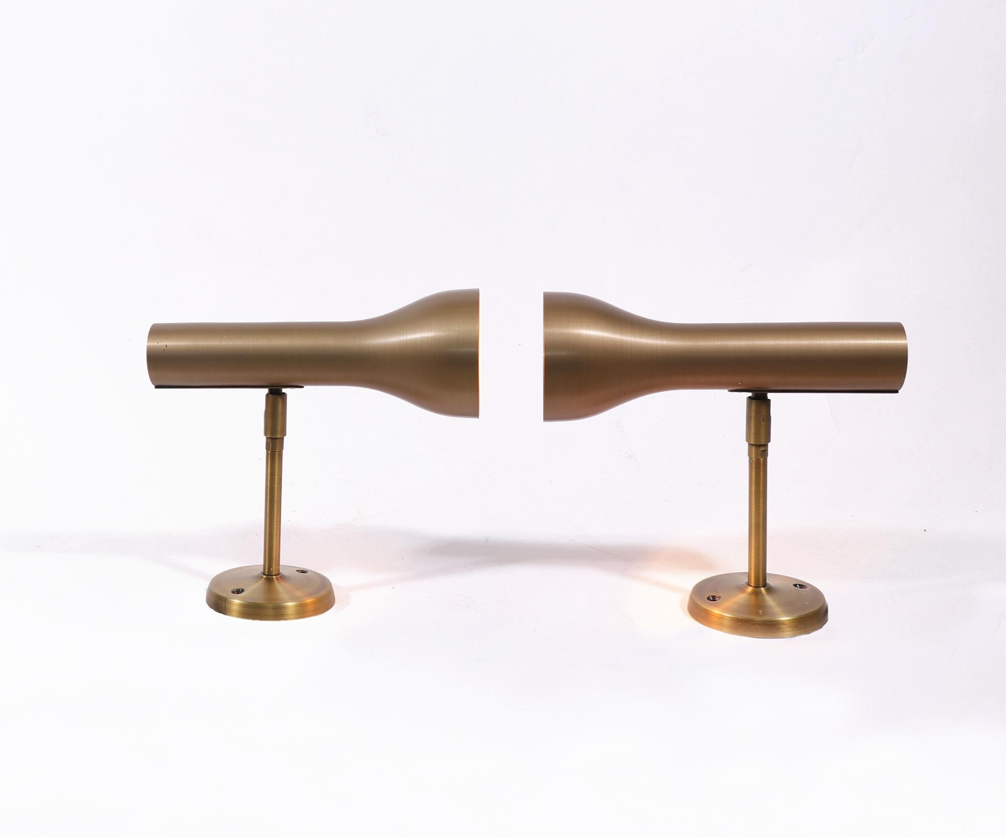Elegant pair of brass wall spots designed by Lad Team for Swiss Lamps International, Zürich in the 1960s.

Lighting: each lamp takes one large Edison bulb. 
Measures: 9