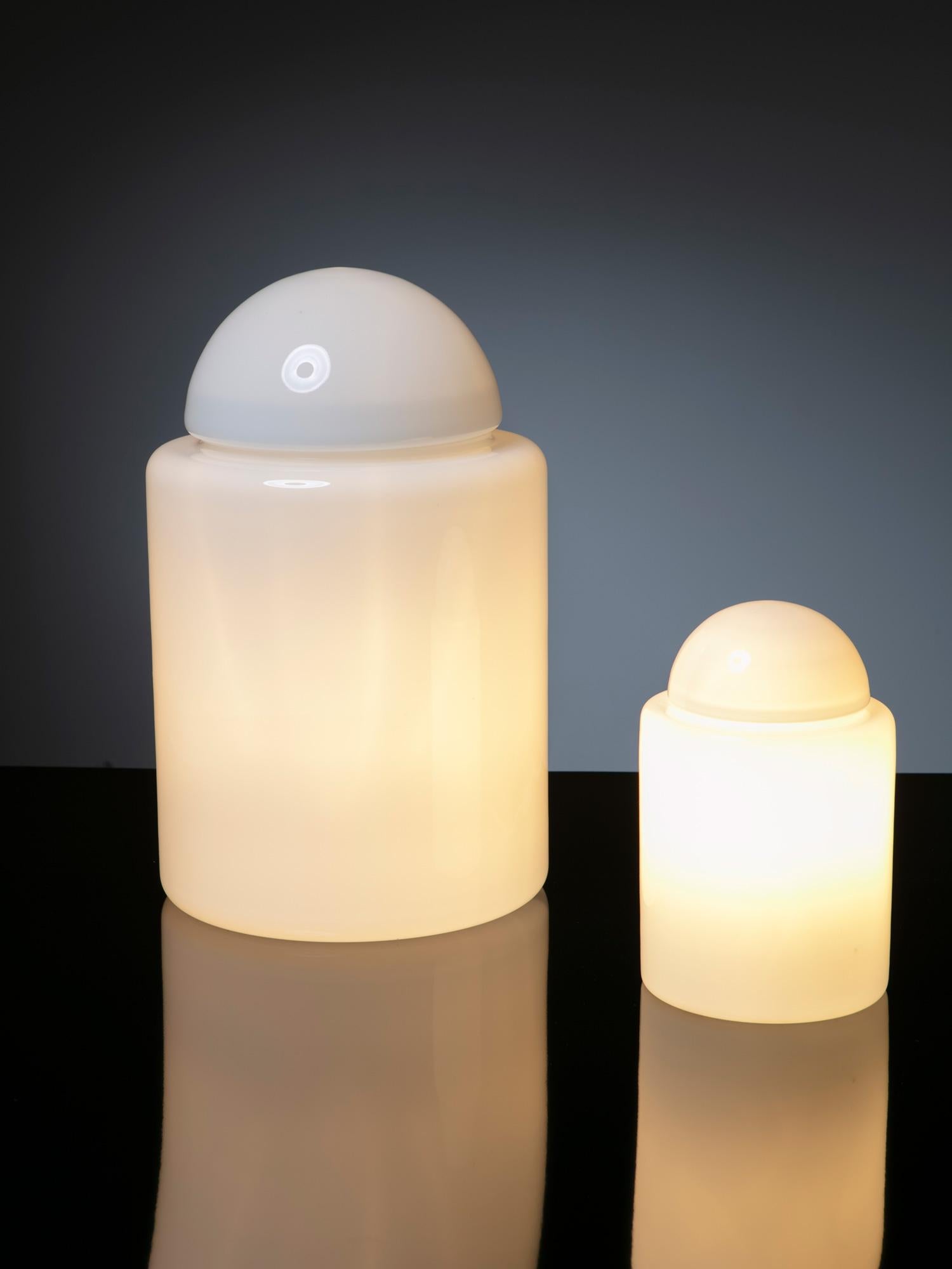 Rare set of two Barattolo table lampsby Sergio Asti for Candle.
This project follows the steps of the Daruma lamp, with two overlapping milk glass elements creating a familiar lighting object.
Size refers to the biggest piece.