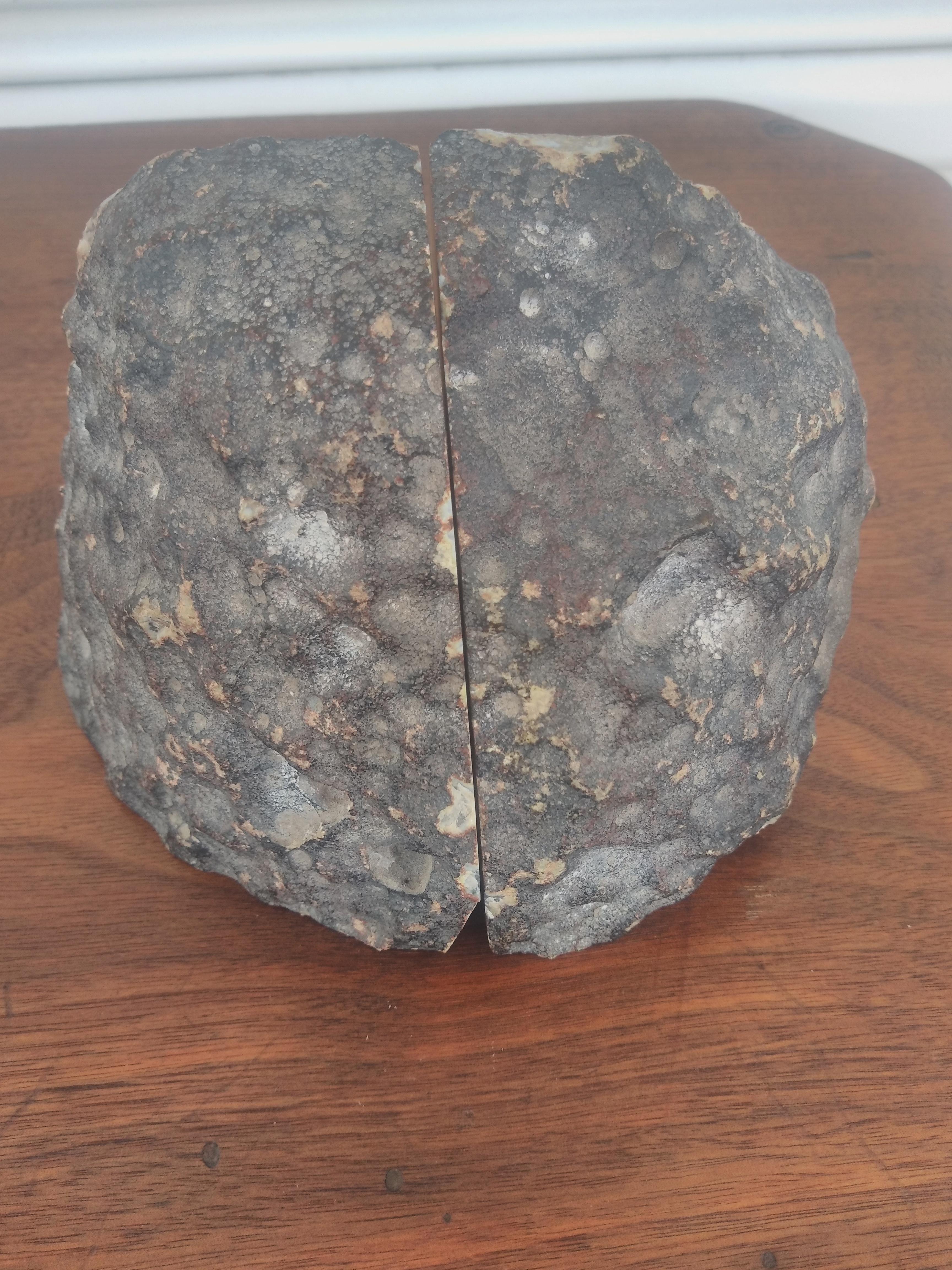 This is a beautiful pair of Brazilian Agate Geode bookends. The crystal is encrusted in a beautiful dark grey rock.
The crystal has dark grey veins running through it. 

A good addition to any office or library.