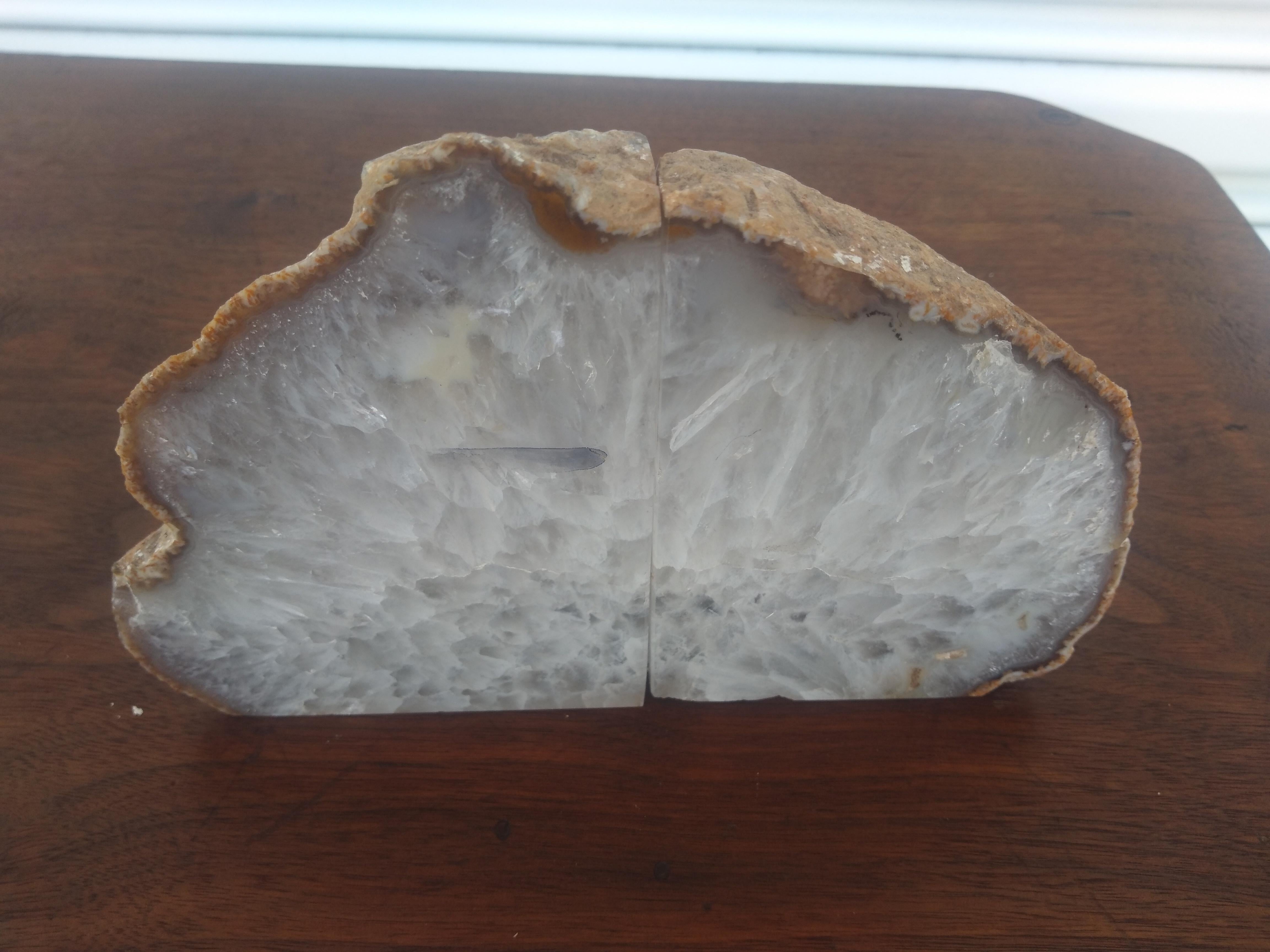 These beautiful Agate Geode Crystalline Bookends come from Brazil. The natural rock is tan colored. Within it is this beautiful crystalline Agate.

A nice addition to any office or library.