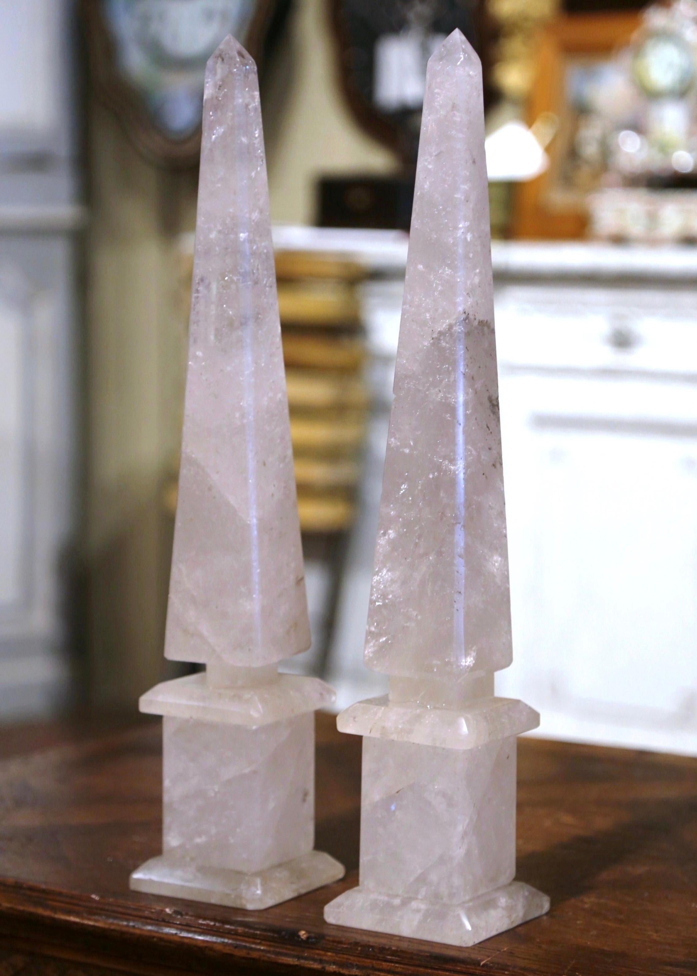 These elegant rock crystal obelisks were crafted in Brazil, each tall piece is raised on a stepped square base and features exquisite craftsmanship with a tapered and pointed stem. Both pieces are in excellent condition with a rich patinated finish.