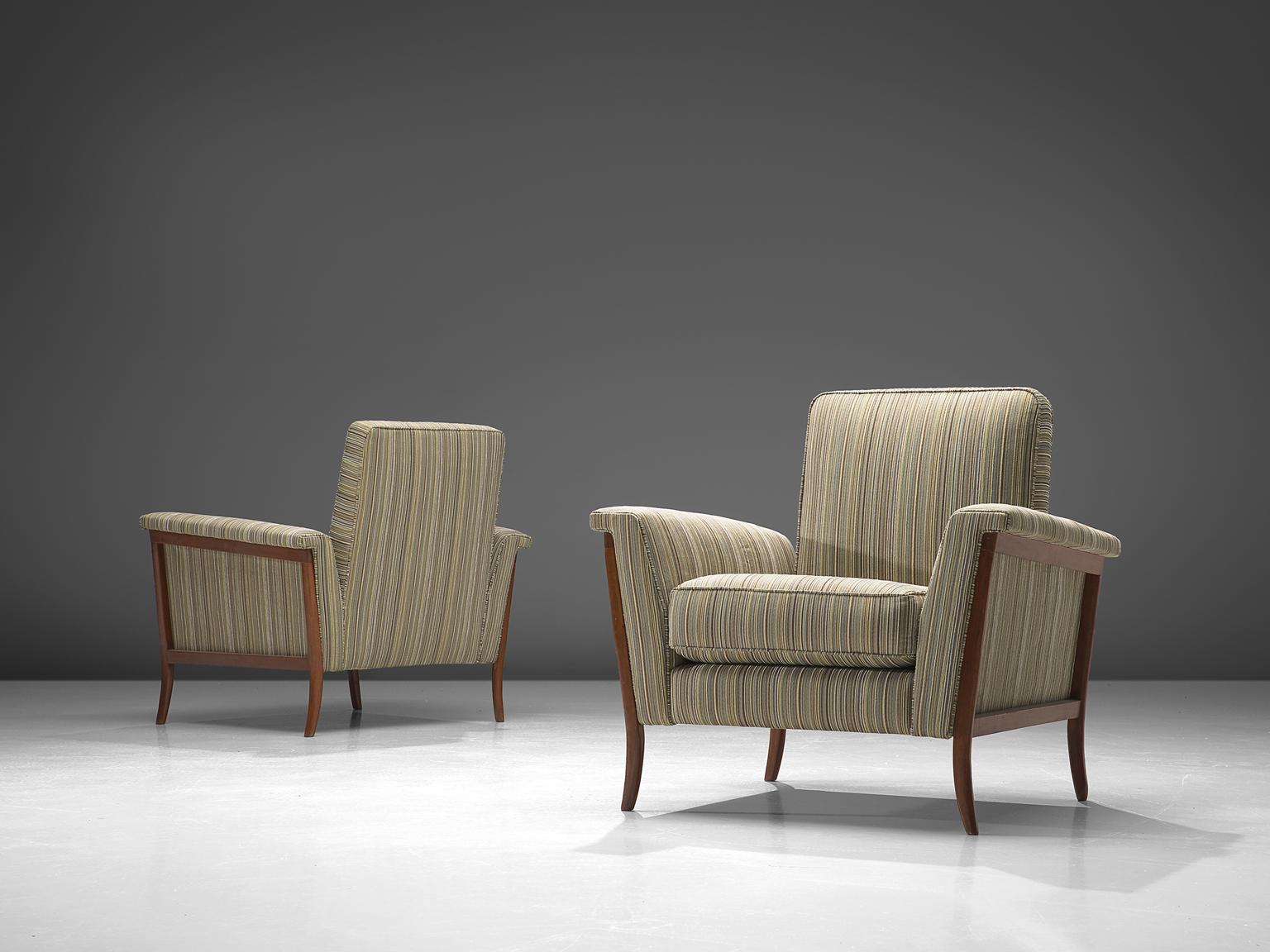 Pair of lounge chairs, in mahogany and fabric, Brazil, 1960s.

Elegant pair of Brazilian club chairs. The curved frame is made of mahogany and beautifully exposed on the outside of the shell. Due the lines the wide character of this chair is