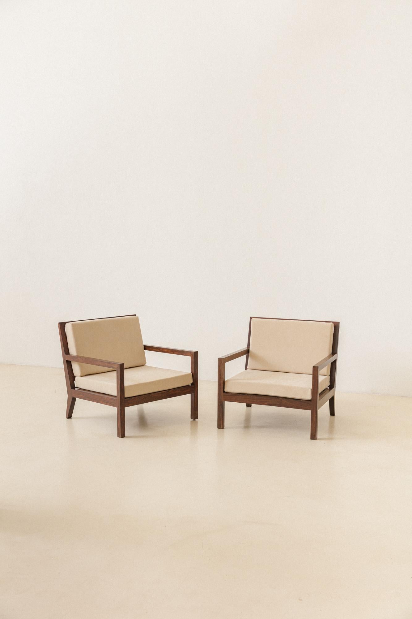 This pair of armchairs with slatted seats and backrests was manufactured in the 1960s, but the authorship is still in research by our team. Pieces are made of solid Brazilian Rosewood and recently reupholstered in gorgeous off-white nubuck leather