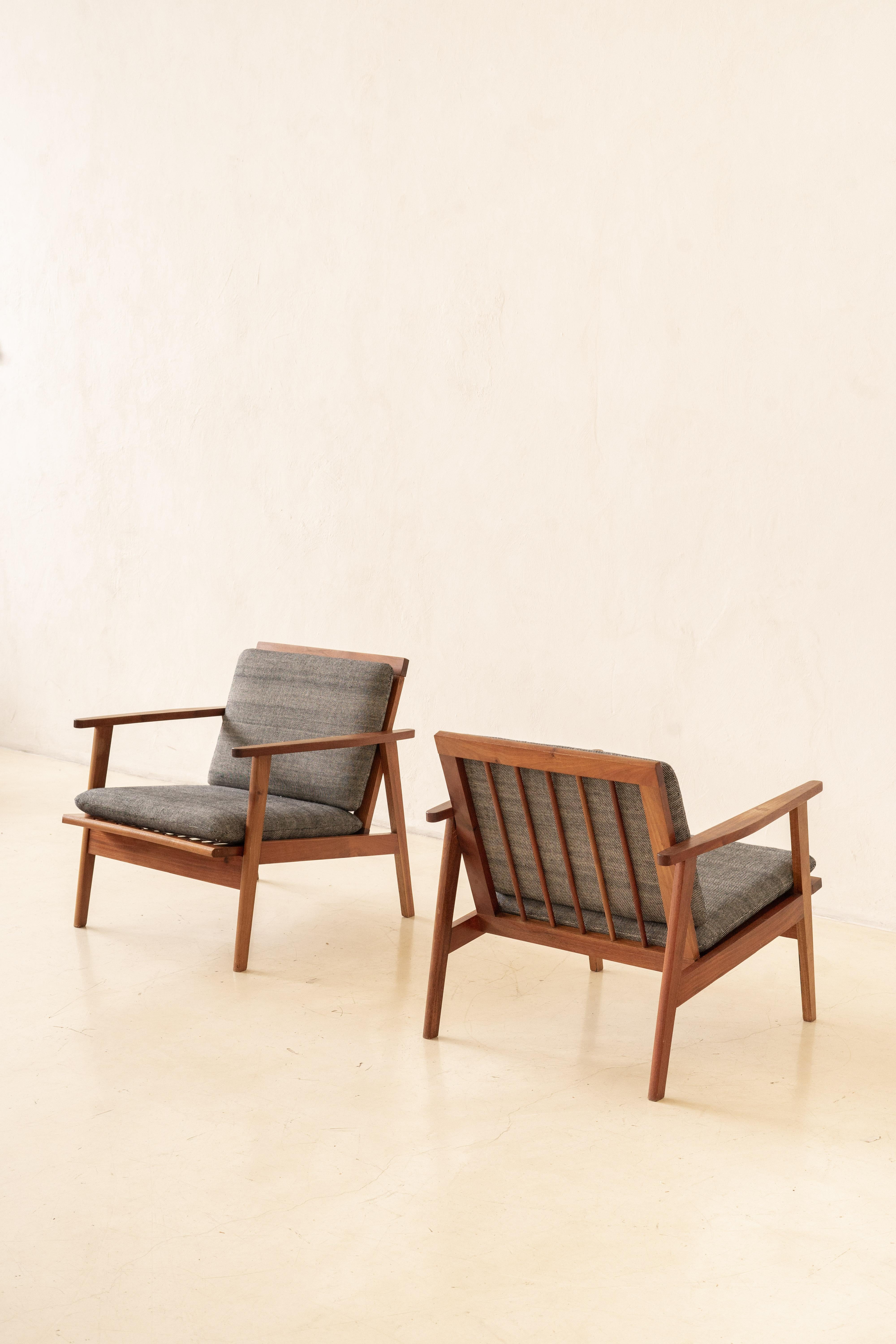 This beautiful pair of armchairs with slatted seats and backs was manufactured in the 1960s.

Pieces are made of solid Brazilian Rosewood. The armchairs have a rectangular design with the backs composed of vertical slats and veins with stunning