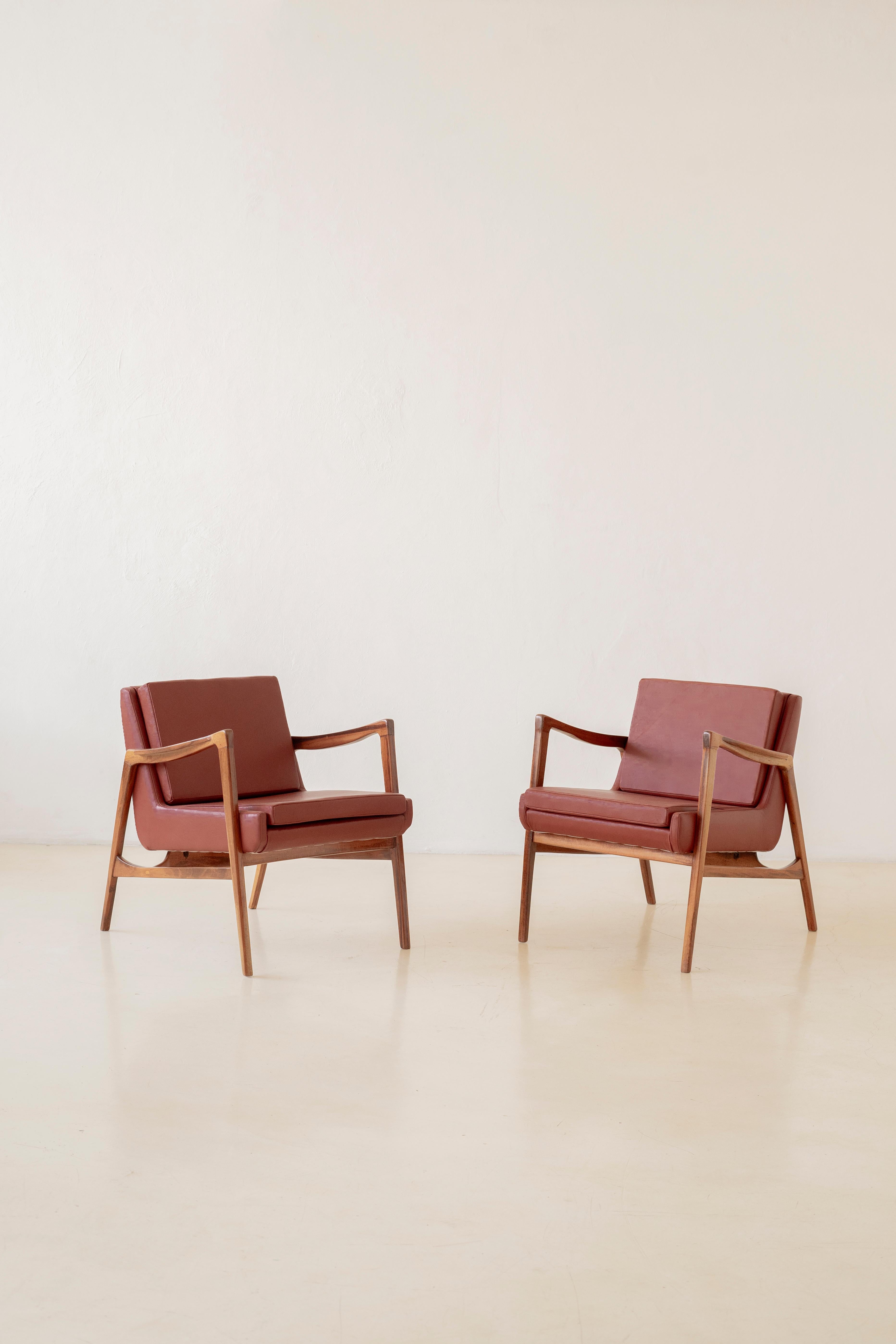 This beautiful pair of armchairs with slatted seats and backs was manufactured in the 1960s.

Pieces are made of solid Brazilian Rosewood. The armchairs have a rectangular design with the backs composed of vertical slats and veins with stunning