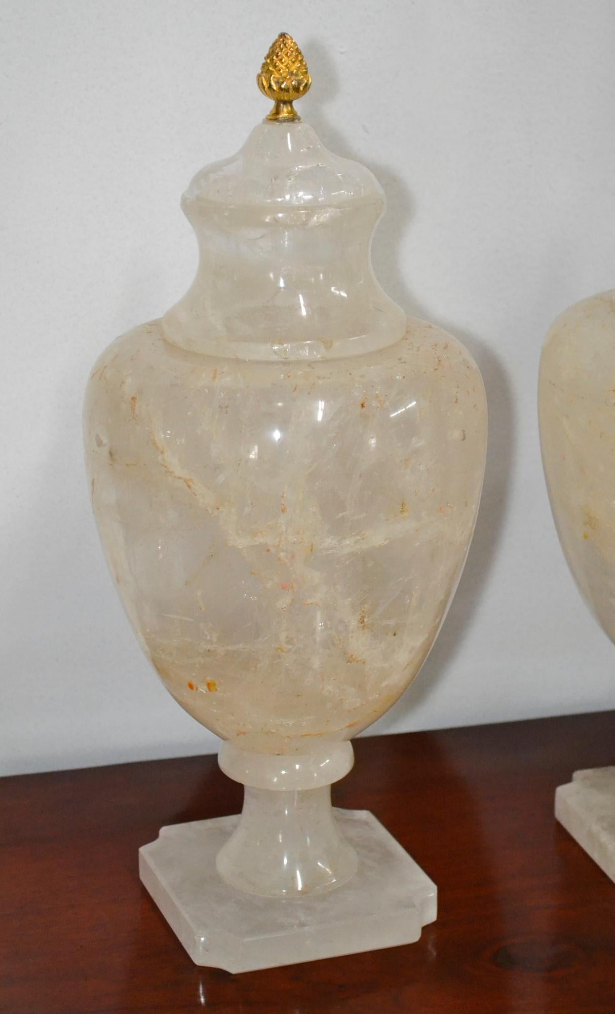 Splendid pair of Brazilian rock crystal urns with gilt finials.