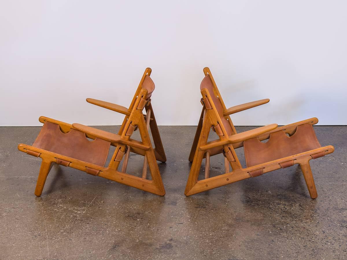 Pair of 1960s Børge Mogensen Hunting Chairs, model no. 2229 for Fredericia Stolefabrik. A daringly low design that predates Mogensen’s iconic Spanish chair.
Original patina glows on the aged saddle leather, sure to become more exquisite with time.