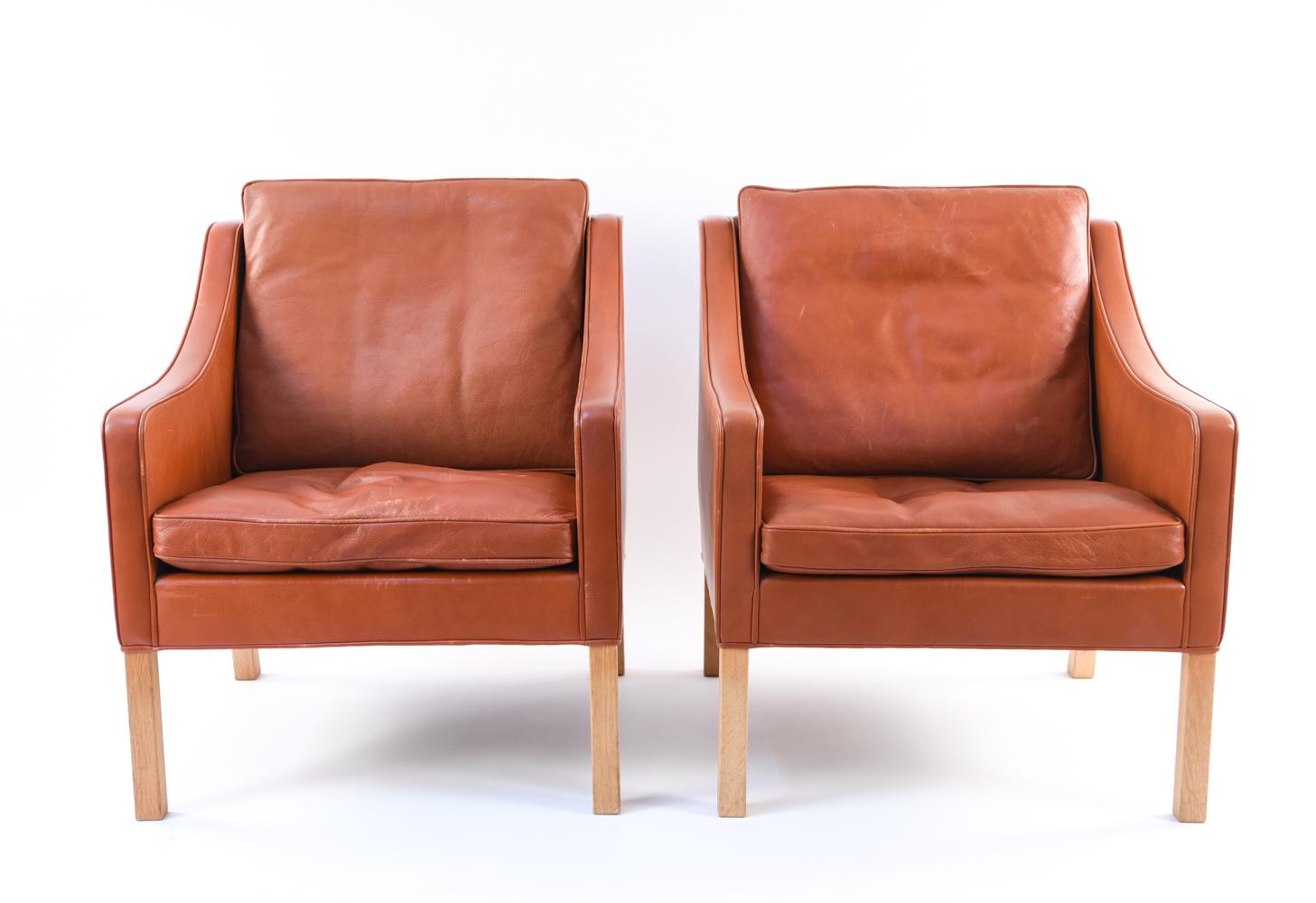 A beautiful pair of Danish midcentury lounge chairs designed by the esteemed Borge Mogensen, model 2207. These chairs are an iconic example of Scandinavian Modern design and have inspired decades of reproductions. These original chairs shows