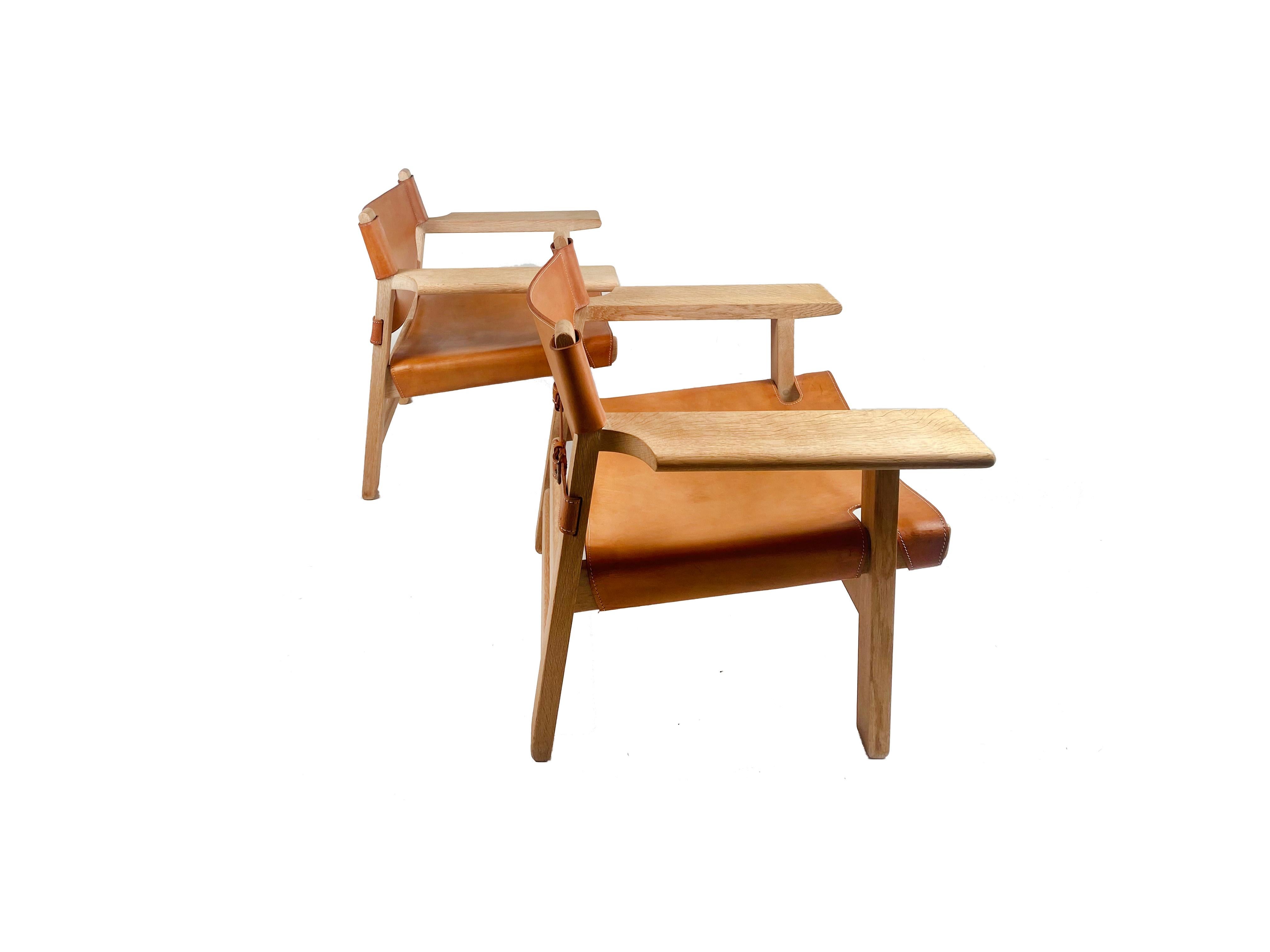 A pair of Borge Mogensen’s iconic Spanish Chairs for Fredericia Stolefabrik, Denmark in original cognac leather. Pair has been lovingly cared for and is distinguished by it’s own age-appropriate characteristics. Gorgeously aged oak frames boast a