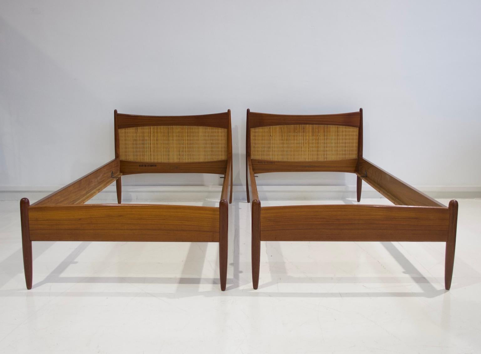 Pair of teak wood bed frames with rattan headboard from the 1950s. Designed by Børge Mogensen and manufactured in Denmark. Stamped by maker. Easy to dismantle for shipping and then assemble. Beautiful pieces for guest or children bedrooms. Please