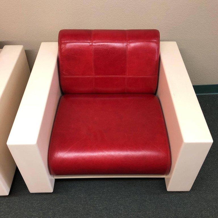 A pair of unique armchairs. The chairs were designed by Brian Kane for Metropolitan Furniture. The chairs were produced in the 1980s. The shell is molded fiber glass and finished in off-white. The seat and back cushions are upholstered in lipstick