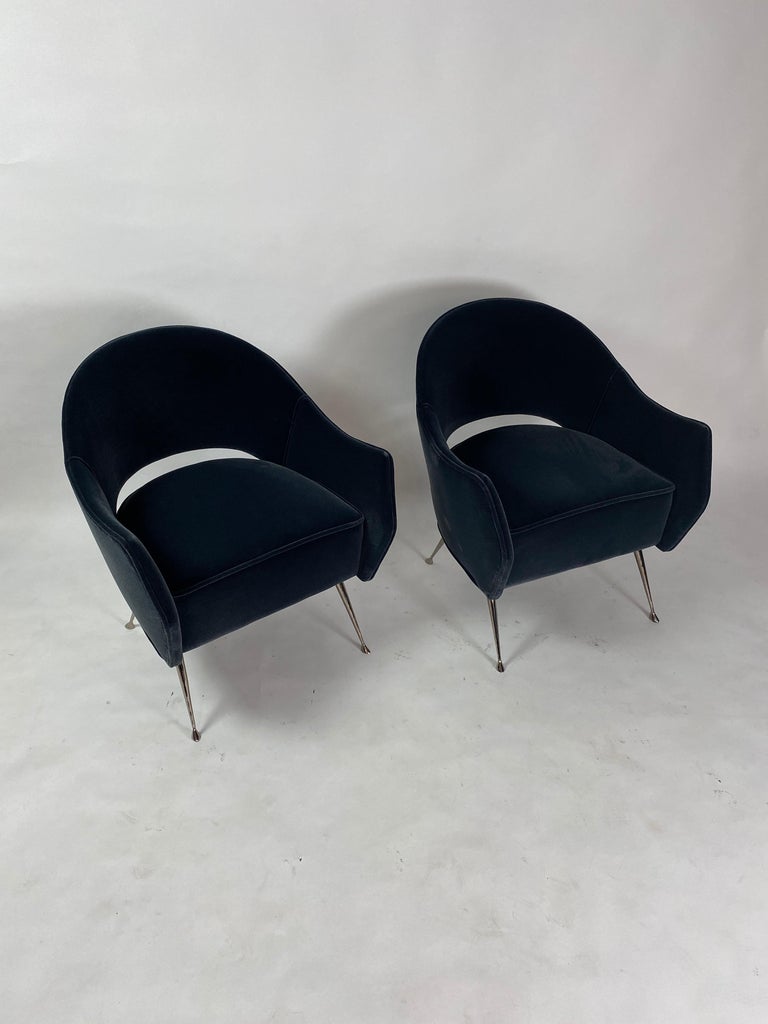 These elegant chairs have cast brass legs which have been black nickel-plated and a distinctive curved back. The chairs are very comfortable, perfect in size and are ideal as small-scale side chairs. The beauty of the tapered legs with their