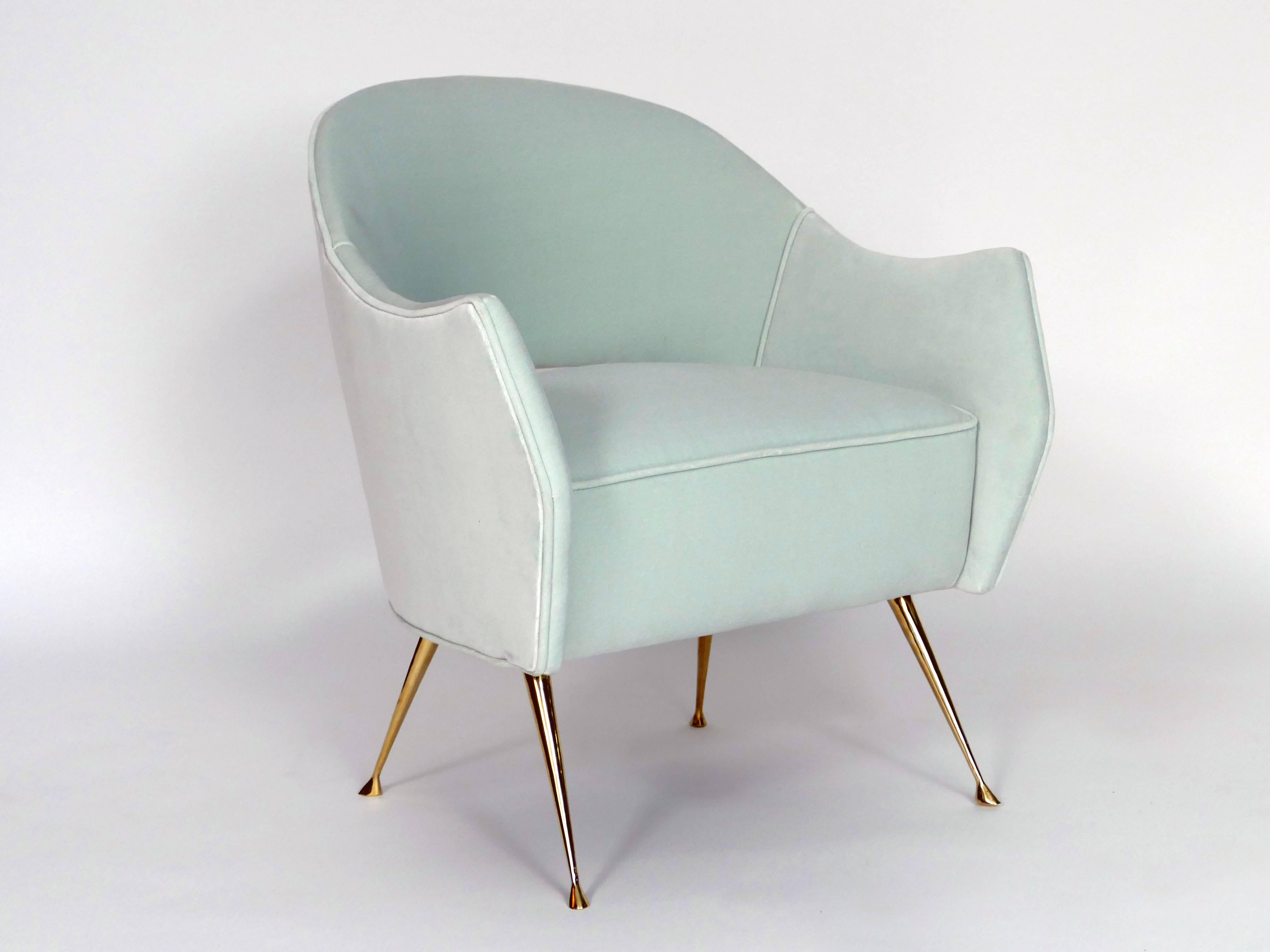 These elegant chairs have cast brass legs and a distinctive curved back. The chairs are very comfortable, perfect in size and are ideal as small-scale side chairs. The beauty of the tapered brass legs with their graceful feet are sure to add that
