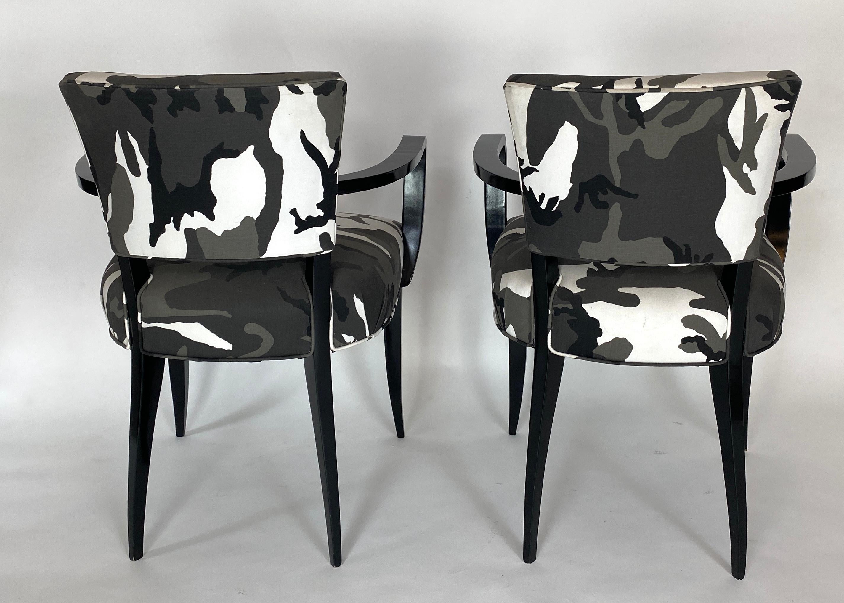 Pair of French 1940s bridge armchairs. Restored with a black lacquered finish and recovered with urban camouflage fabric. A classic armchair with a twist.