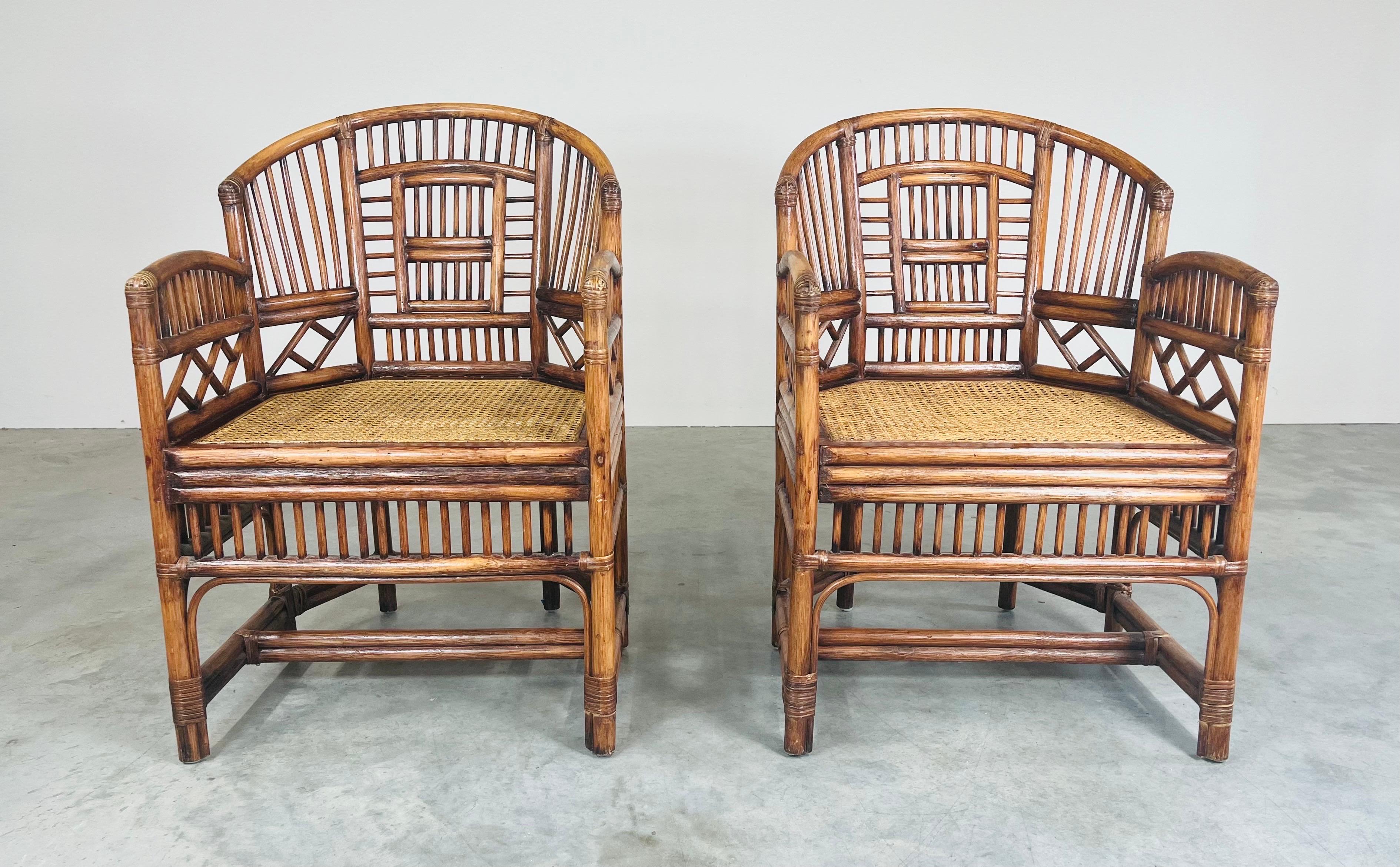 An elegant pair of Brighton Pavilion style chairs having wide seats for comfort with intricate bamboo frames throughout and firm cane seats. 
 In very good vintage condition with fresh seat caning and solid frames. No breaks or holes to the cane