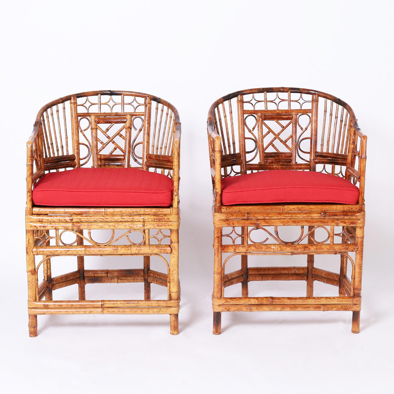 Mid-century pair of the iconic Brighton Pavilion chairs crafted in bamboo and rattan with caned seats in an Asian form with chippendale influences.