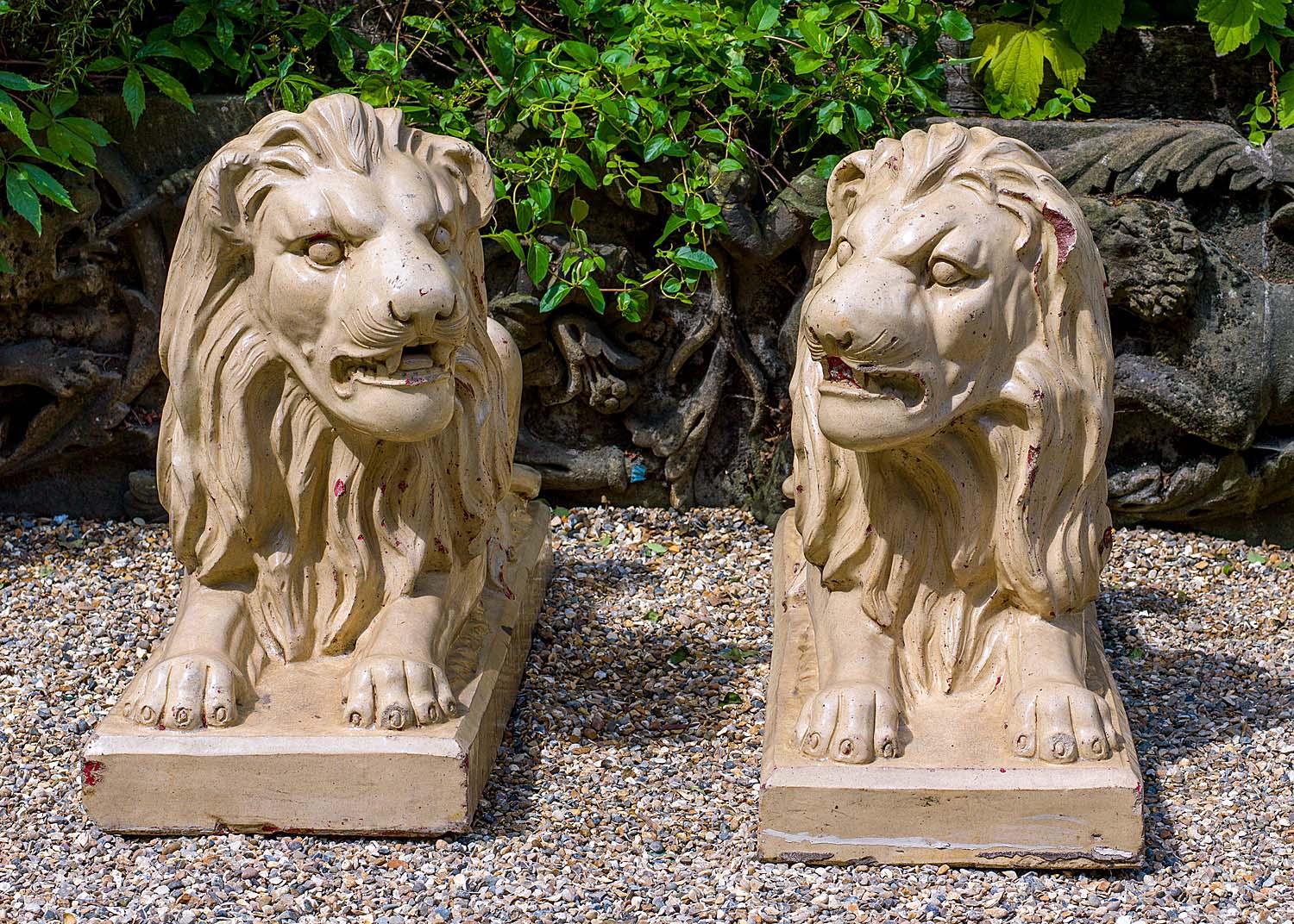 A pair of large Bristol glazed antique garden recumbent lions, English, 19th century.