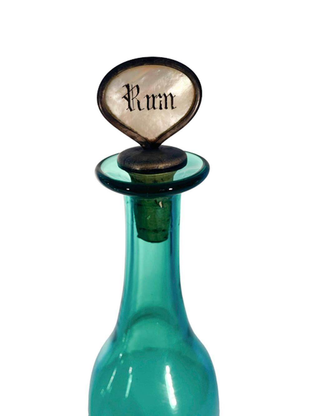 Tall thin pair of Mid-19th Century table bottles or decanters in Bristol green with metal mounted cork stoppers having integral shell labels etched 'Rum' and 'Port'.