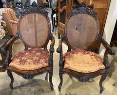 Pair of British 19th Century Carved Walnut Open Armchairs w/ Caned Backs & Seats