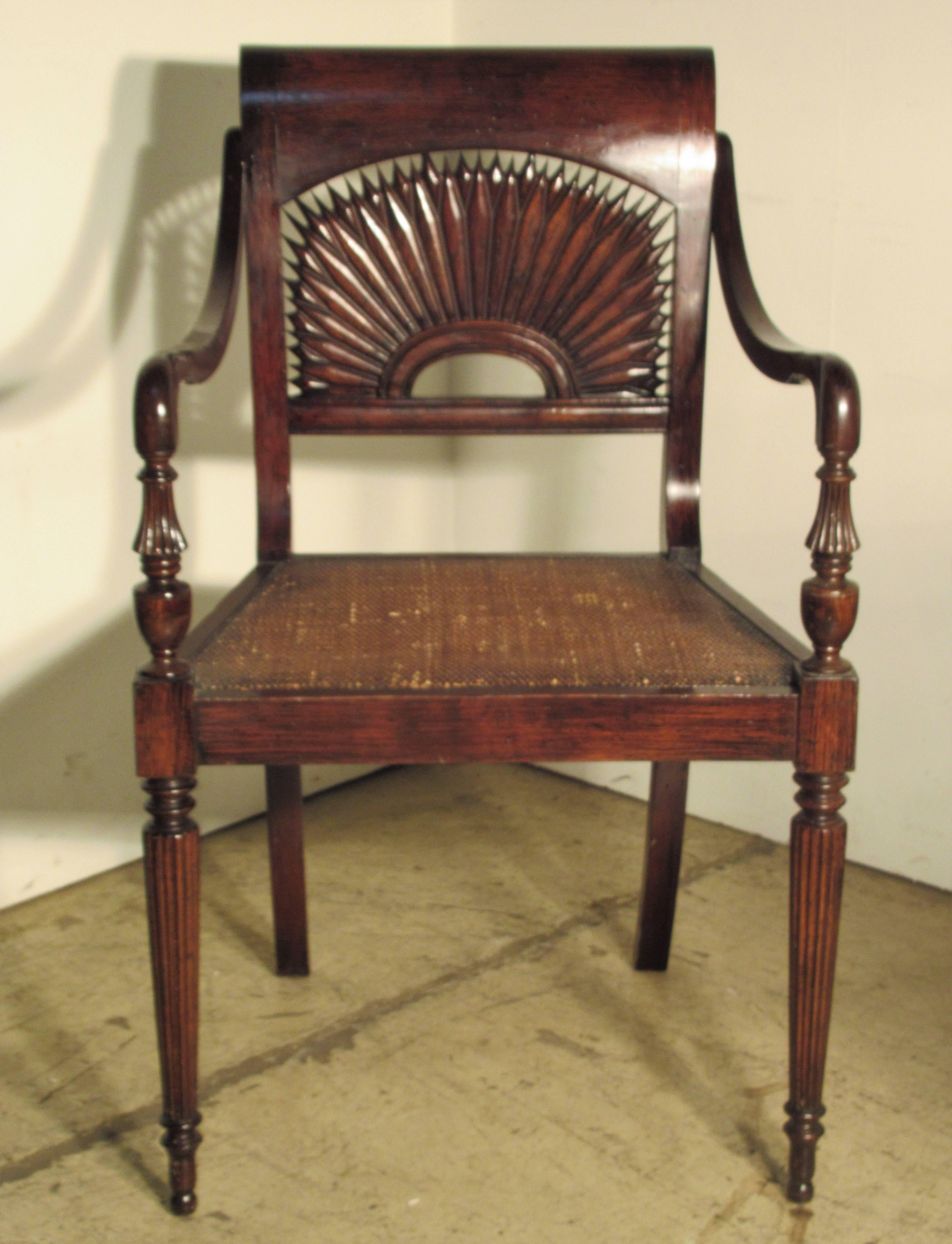 A pair of British Colonial style faux rosewood grained cane seat armchairs with finely carved sunburst backs and reeded legs. A very formal good looking design. Stamped on underside - Made in Italy, circa 1940-1960.