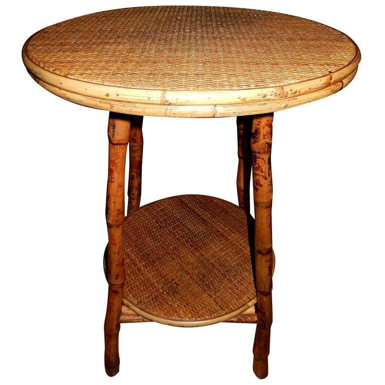 Pair of British Colonial style faux  tortoise shell bamboo and cane side tables. Two levels, great for a lamp, books on second  level. A style that is transitional, which blends in with contemporary settings or traditional, timeless.