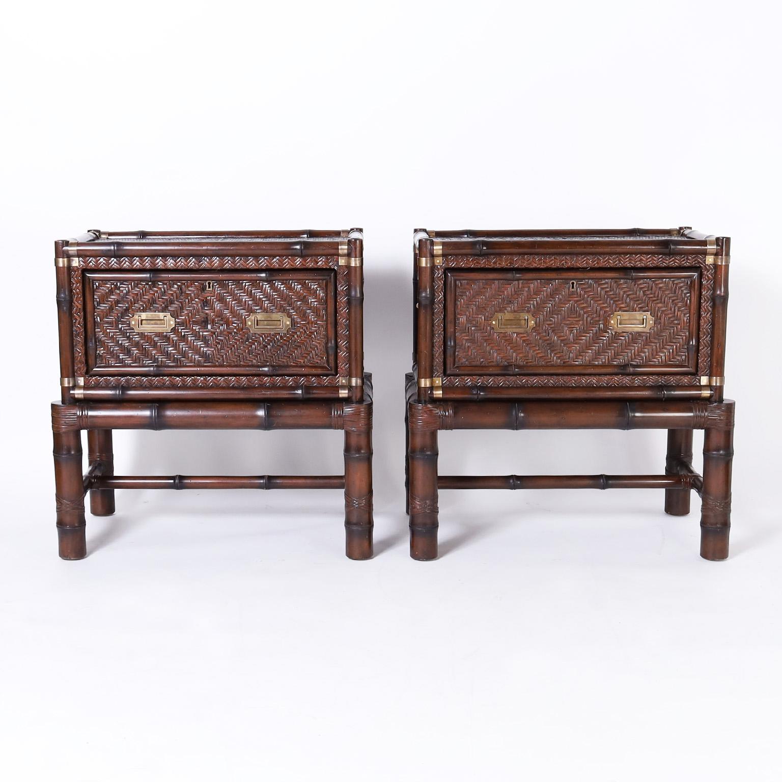 Handsome pair of chests on stands having a one drawer chest with a bamboo frame, campaign brass hardware and woven reed panels in a herringbone design, on a bamboo stand with reed wrapped joints. Signed Ralph Lauren in a drawer.