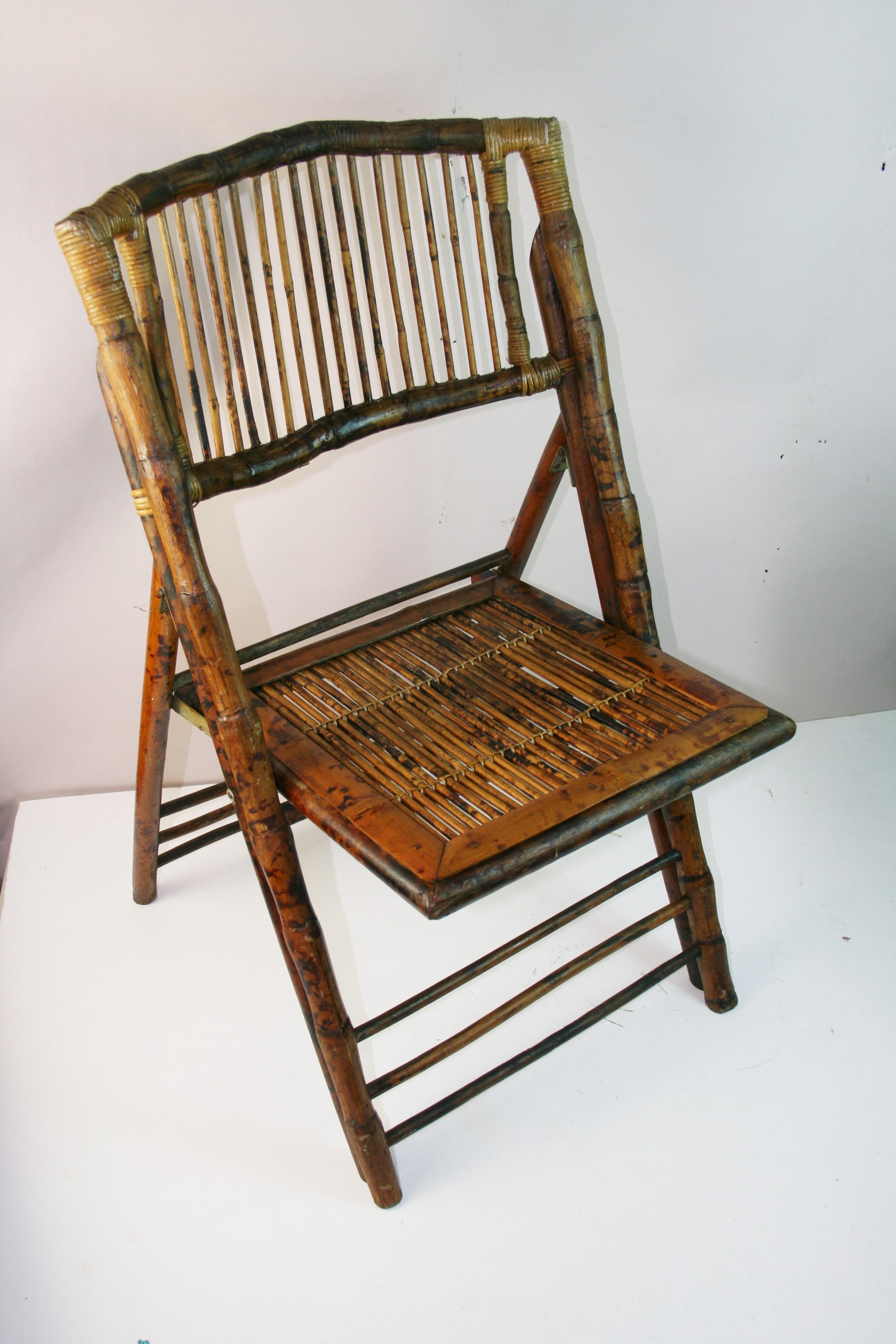 1873 set of 2 English vintage bamboo side chairs featuring tiger wood design and folding frame for easy storage
Features slightly curved slatted backs.
seat height 18