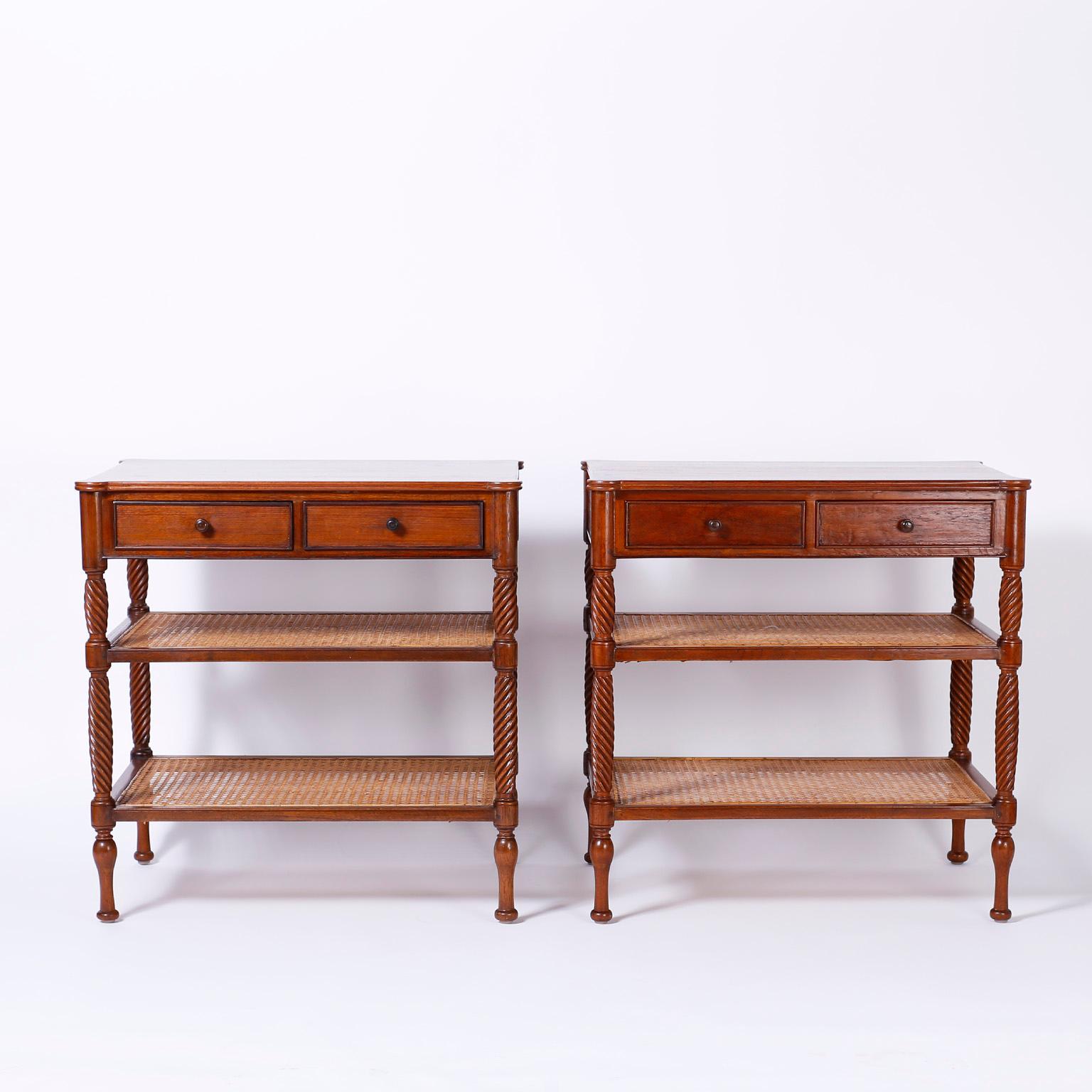 Handsome pair of mahogany nightstands or end tables with two drawers at the top over two hand canned lower tiers supported by carved barley twist posts on turned feet.