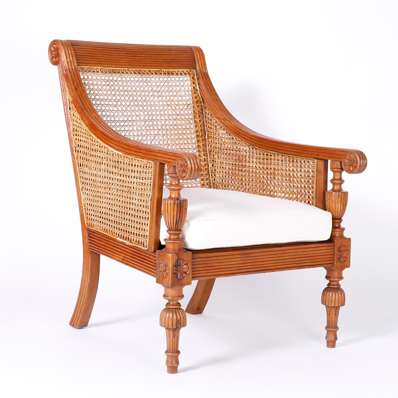 Pair of antique Anglo-Indian matching armchairs. Crafted in teak wood with pegged construction carved and beaded frames, with caned backs and seats and Classic carved, turned legs.