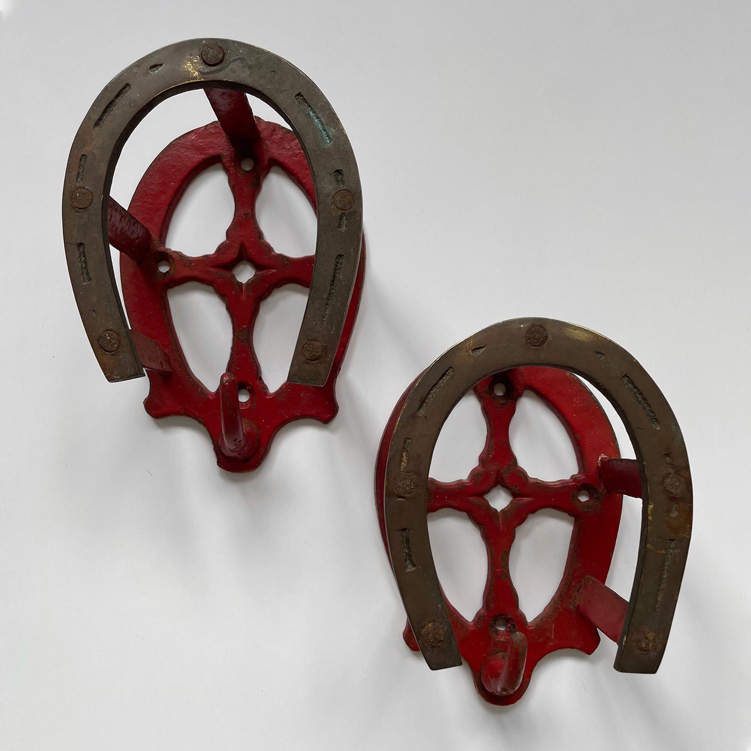 Pair of British equestrian wall hooks
England, early 20th century
Aged brass horseshoe hooks are wonderfully contrasted against the vibrant fire engine red paint
Heavy weight and durable, these hooks provide double storage
The upper portion