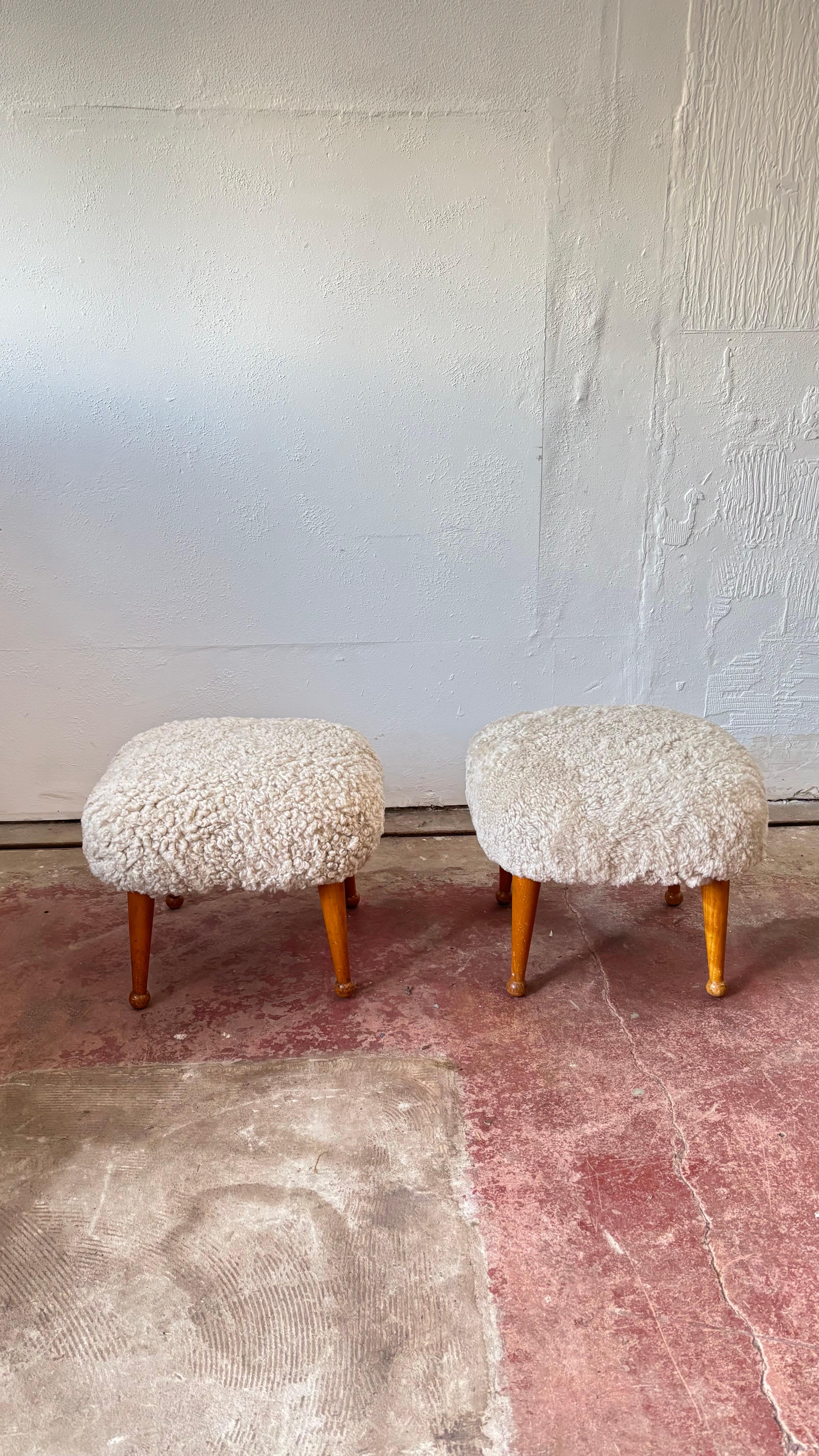 A pair of British Shearling covered footstools. The soft squared top has four shapely legs with a taper to a a ball foot.

These footstools date from the late 50's early 60's. They have been re-covered sympathetically I this beautiful natural top