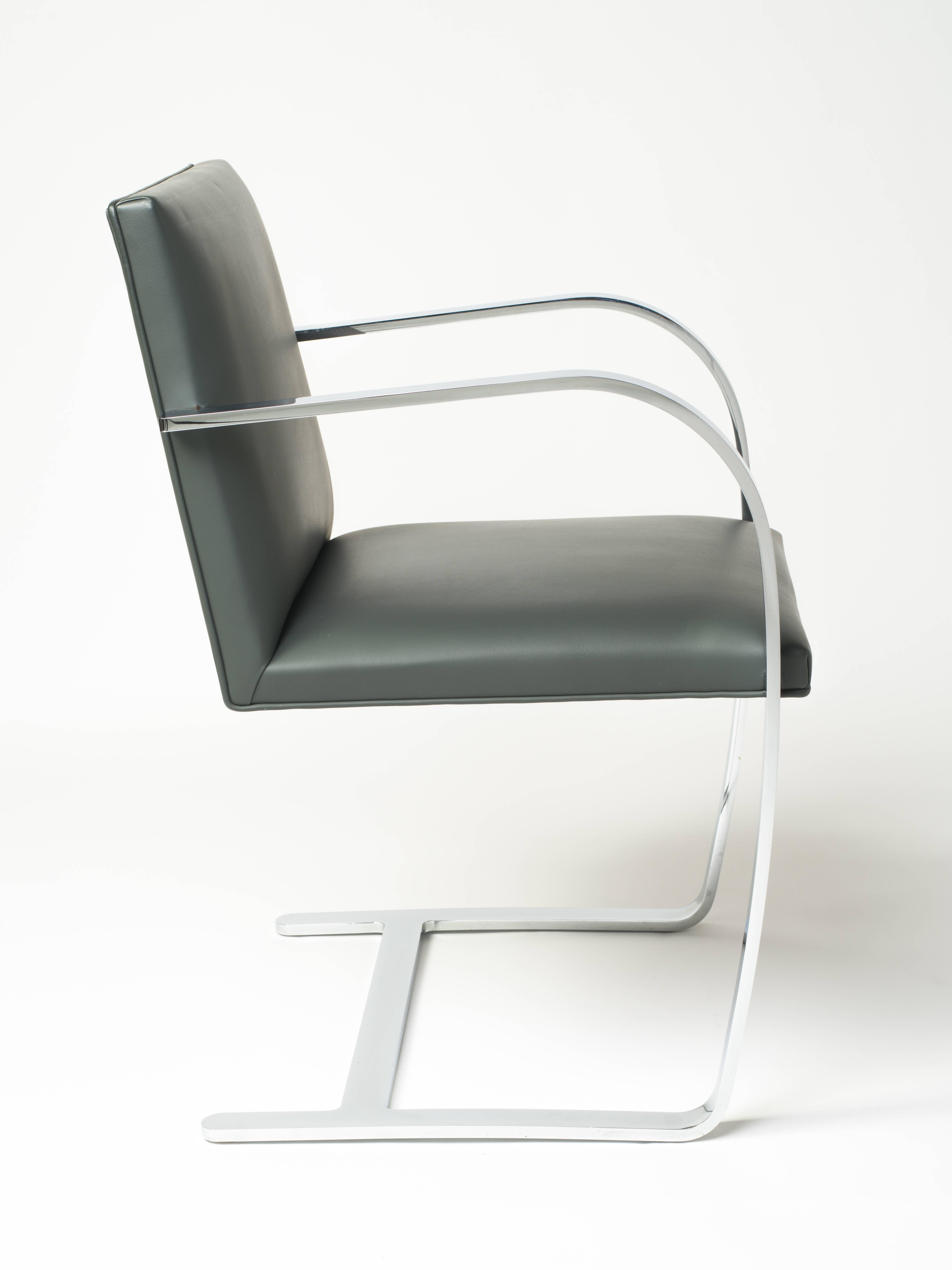 Pair of flat bar Brno chairs in elephant grey leather by Ludwig Mies van der Rohe for Knolls. Iconic Mid-Century Modern design features cantilevered steel frames with polished chrome finish. Frames have skyscraper inspired design with hidden joints