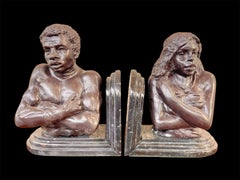 Pair of bronze African male and female figurative bust bookends