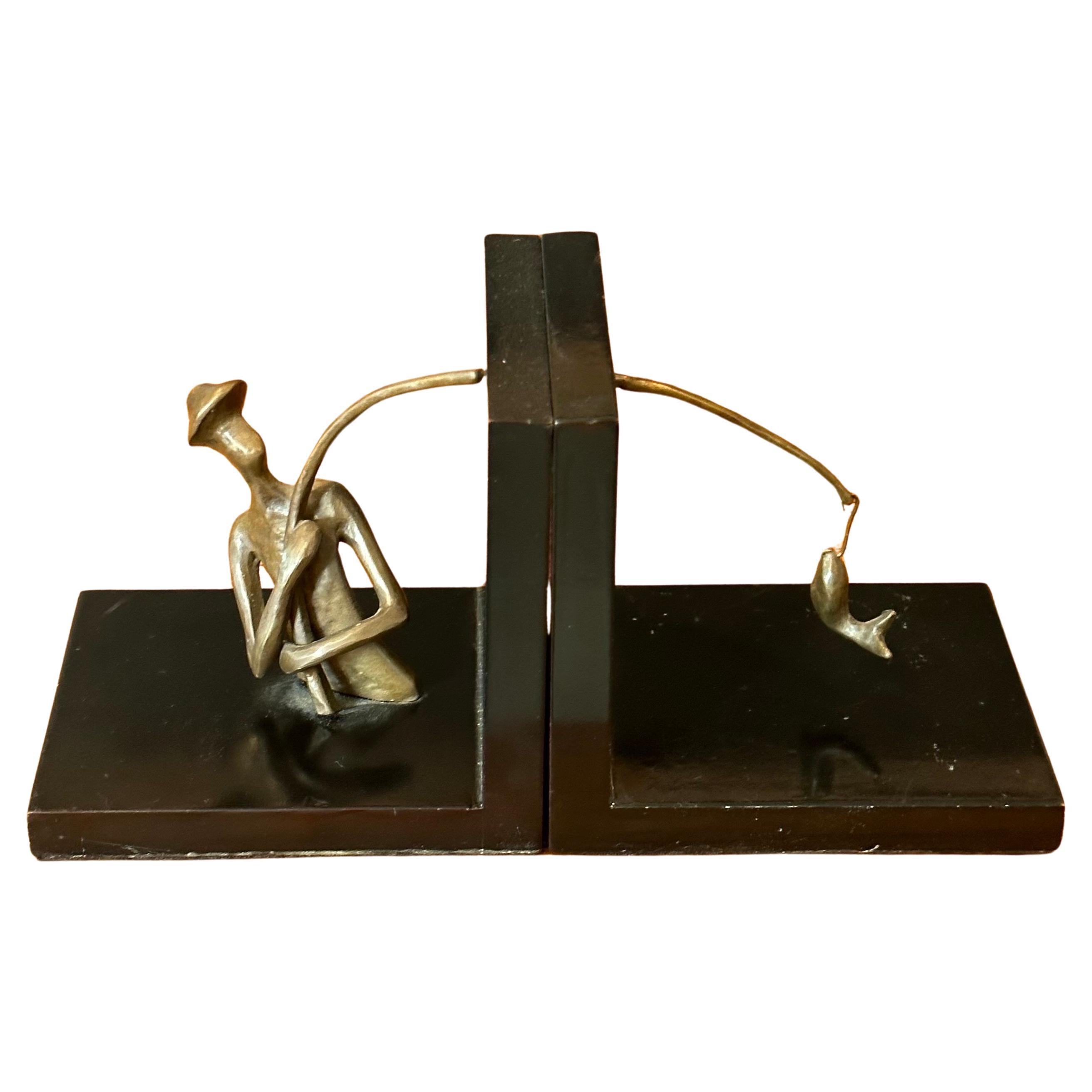 A pair of bronze and black lacquer fisherman bookends., circa 1970s.  The set are in good vintage condition and measure 10.25